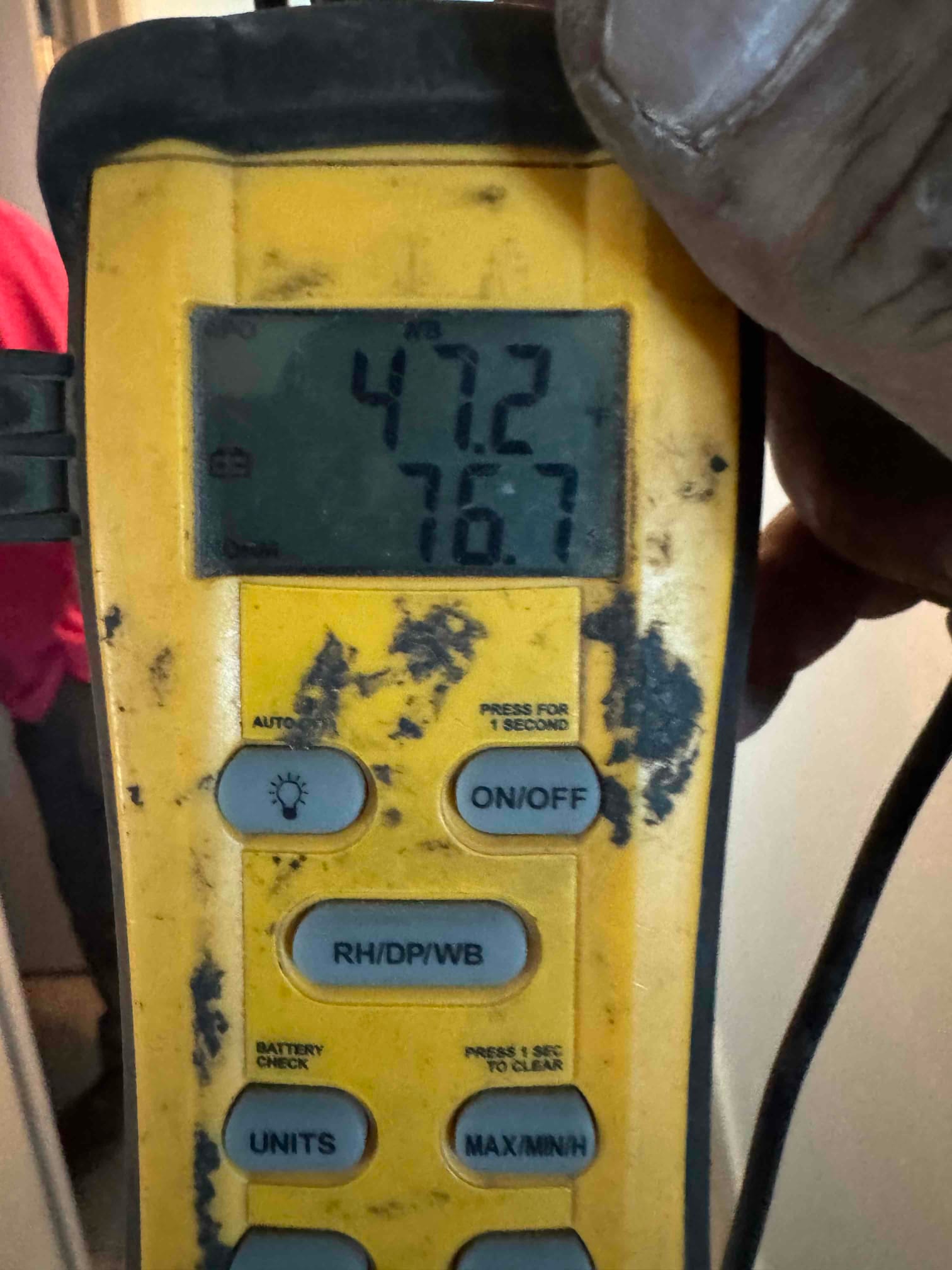 Digital thermometer displays 47.2°F supply air temperature and 76.7°F return air during commissioning of the new system.