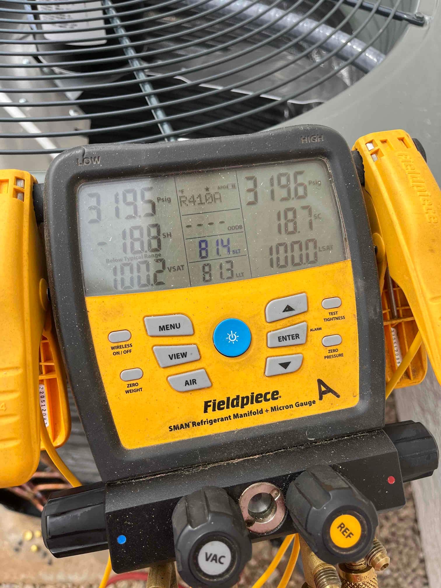 Digital manifold gauges show equal pressures near 319 PSI on both sides during a nitrogen pressure test of the new system.
