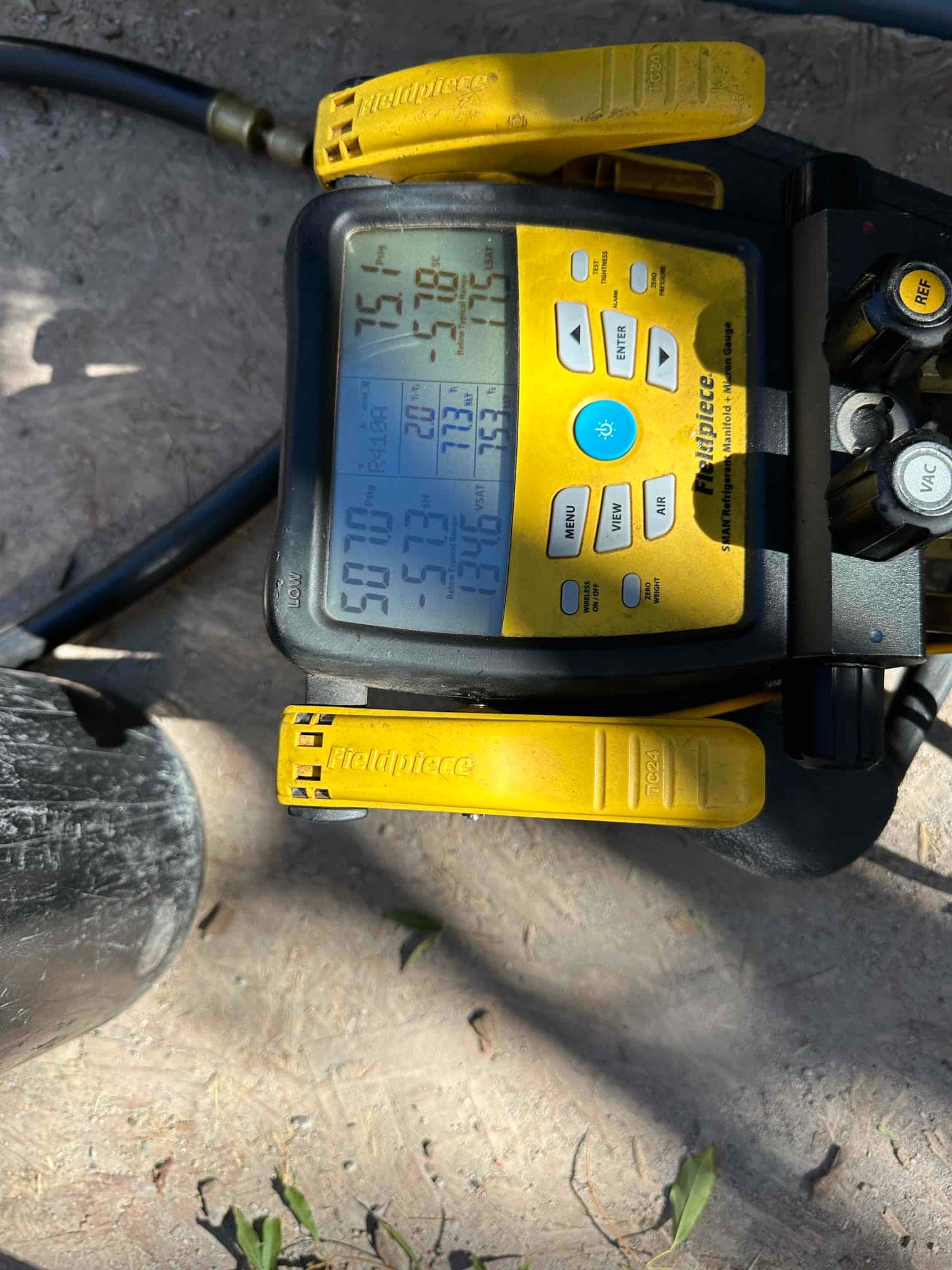 Digital manifold gauges show equalized pressure around 507 PSI on both sides during a nitrogen pressure test of the system.