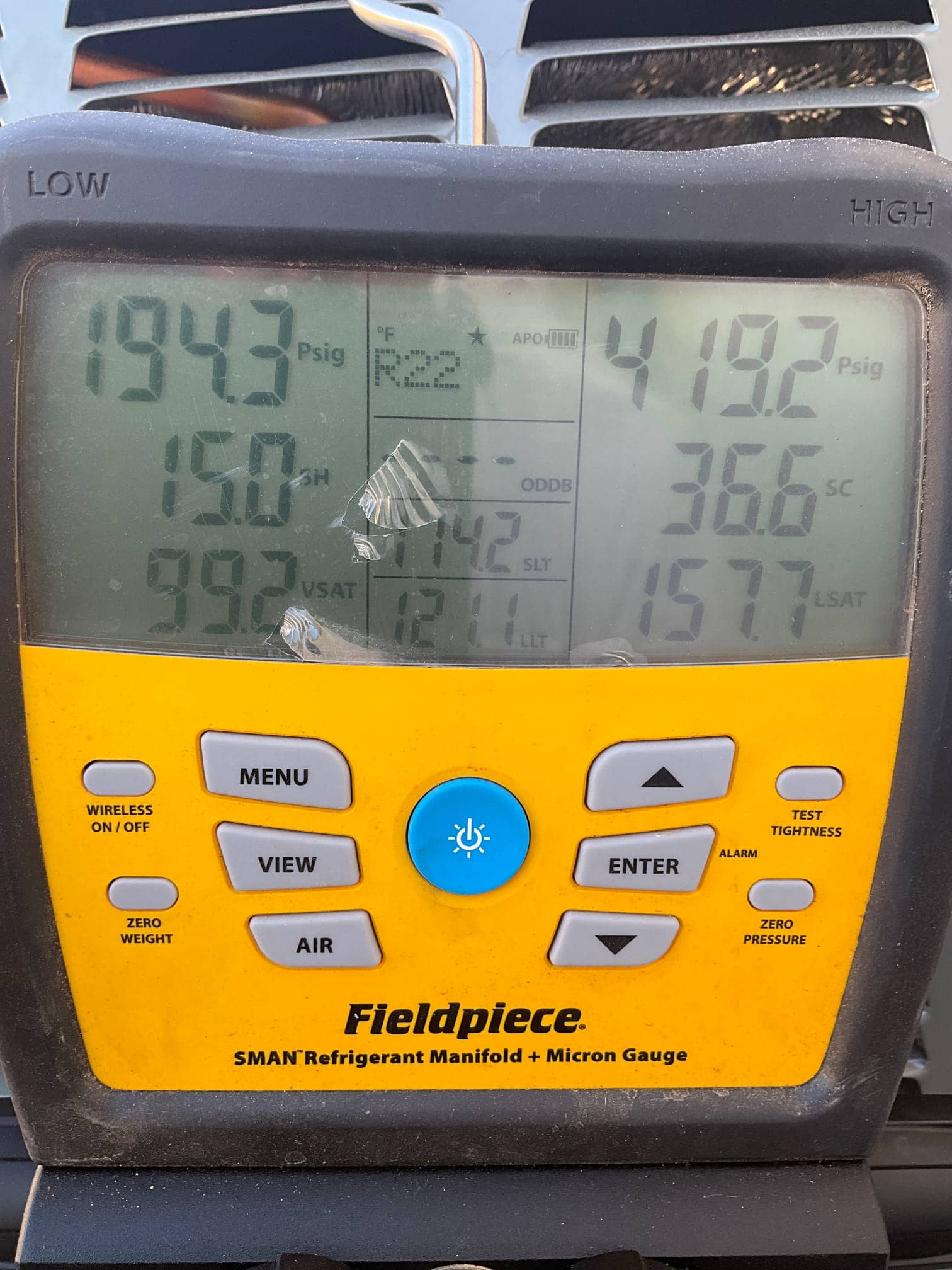 Digital manifold shows operating refrigerant pressures with low side at 194 PSI and high side at 419 PSI during system run.