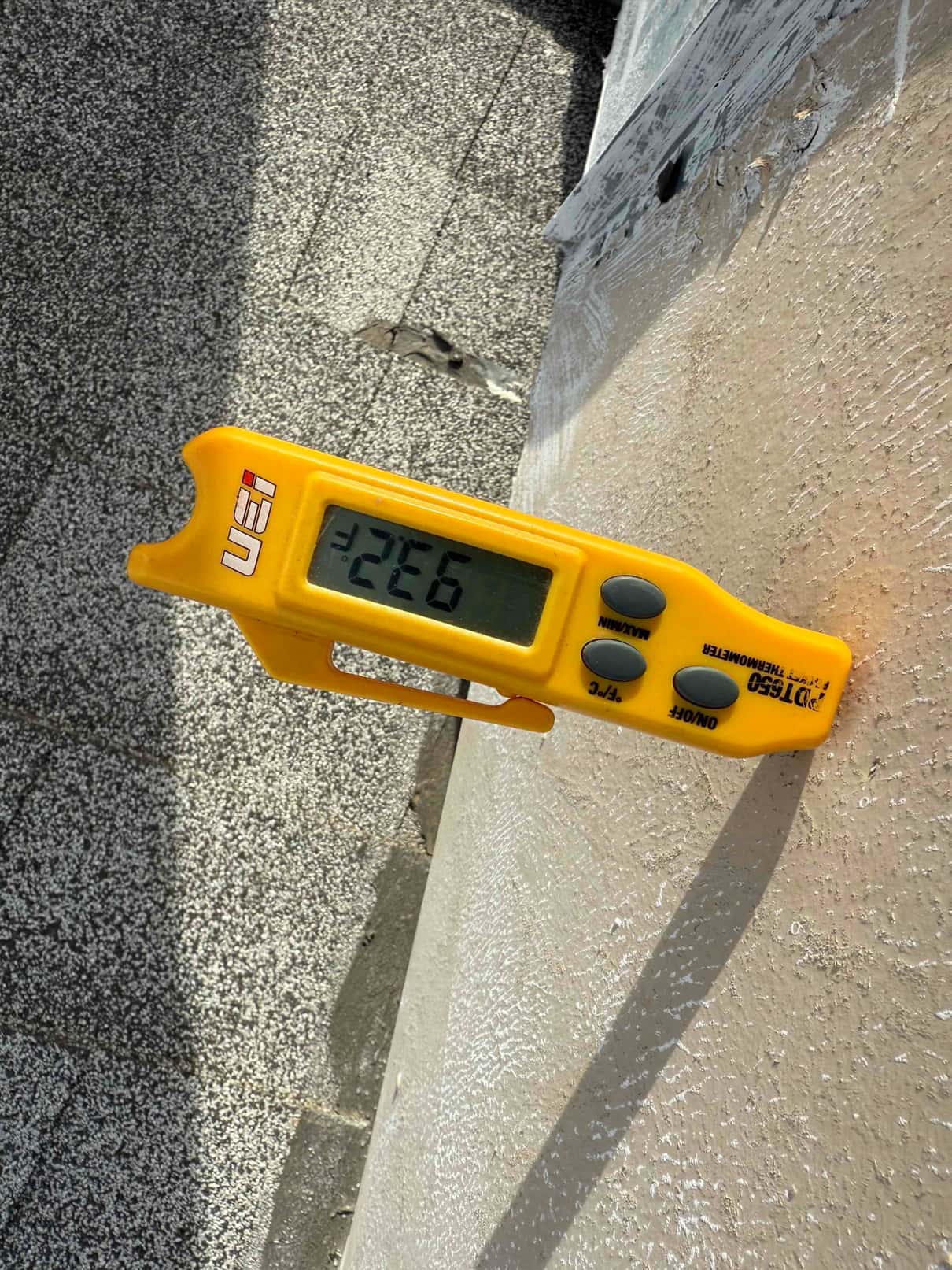 Digital thermometer shows 132.6 °F surface temperature, with the probe inserted into the measured material.