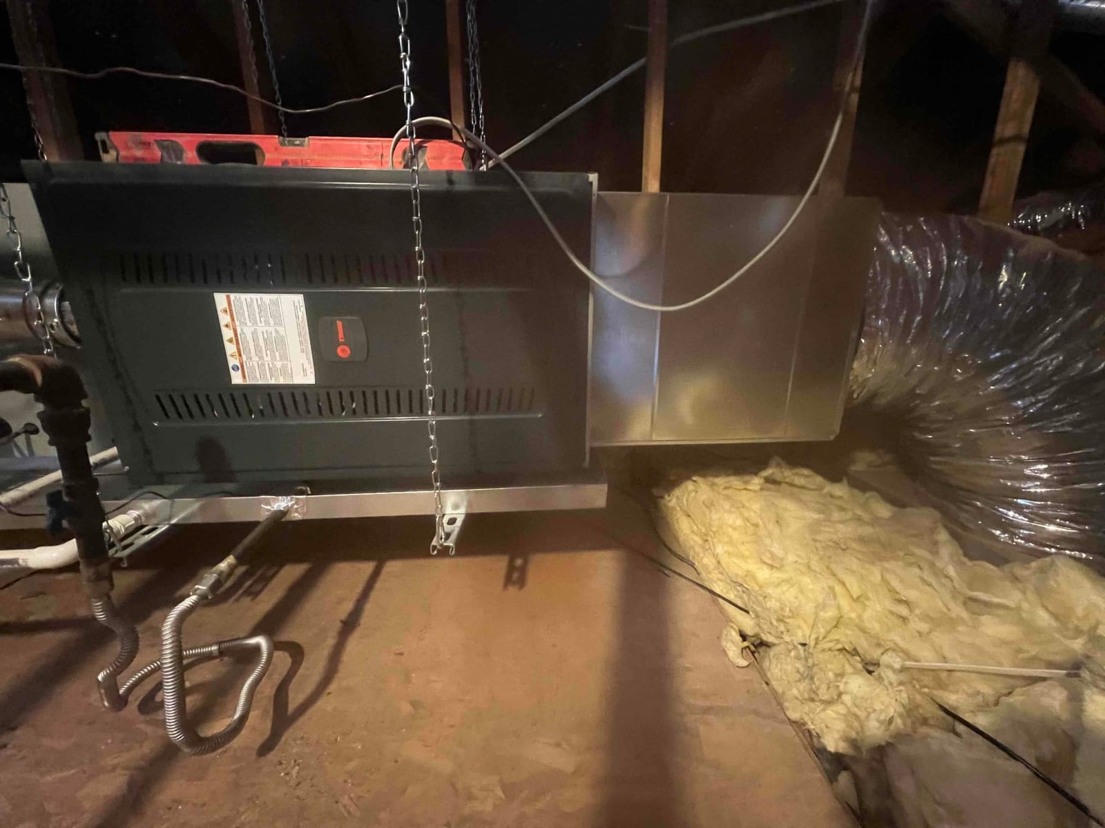 Horizontal attic air handler hung from chains with new sheet-metal plenum and insulated flex duct connected on the supply side.