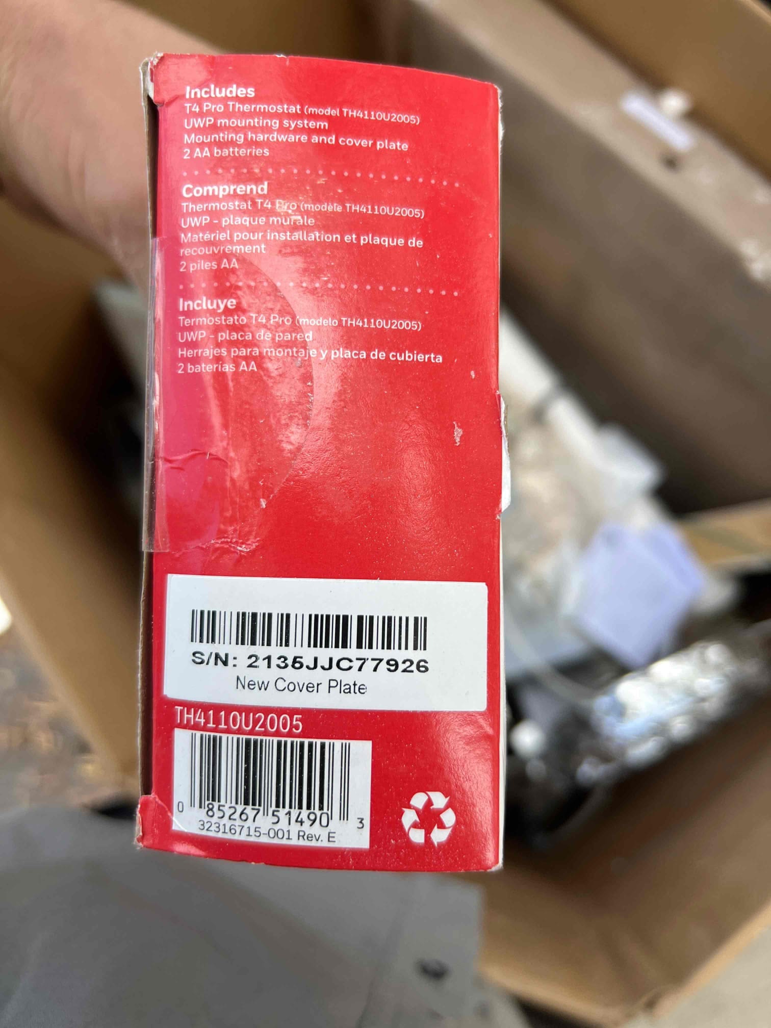 Box for a new wall-mounted thermostat and mounting system shown on site during installation.