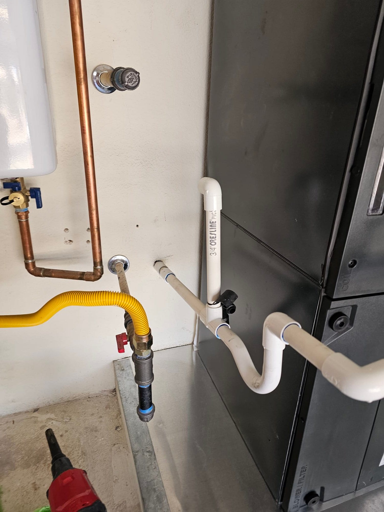 Condensate drain piping with cleanout and trap routed to the air handler on a new metal drain pan.