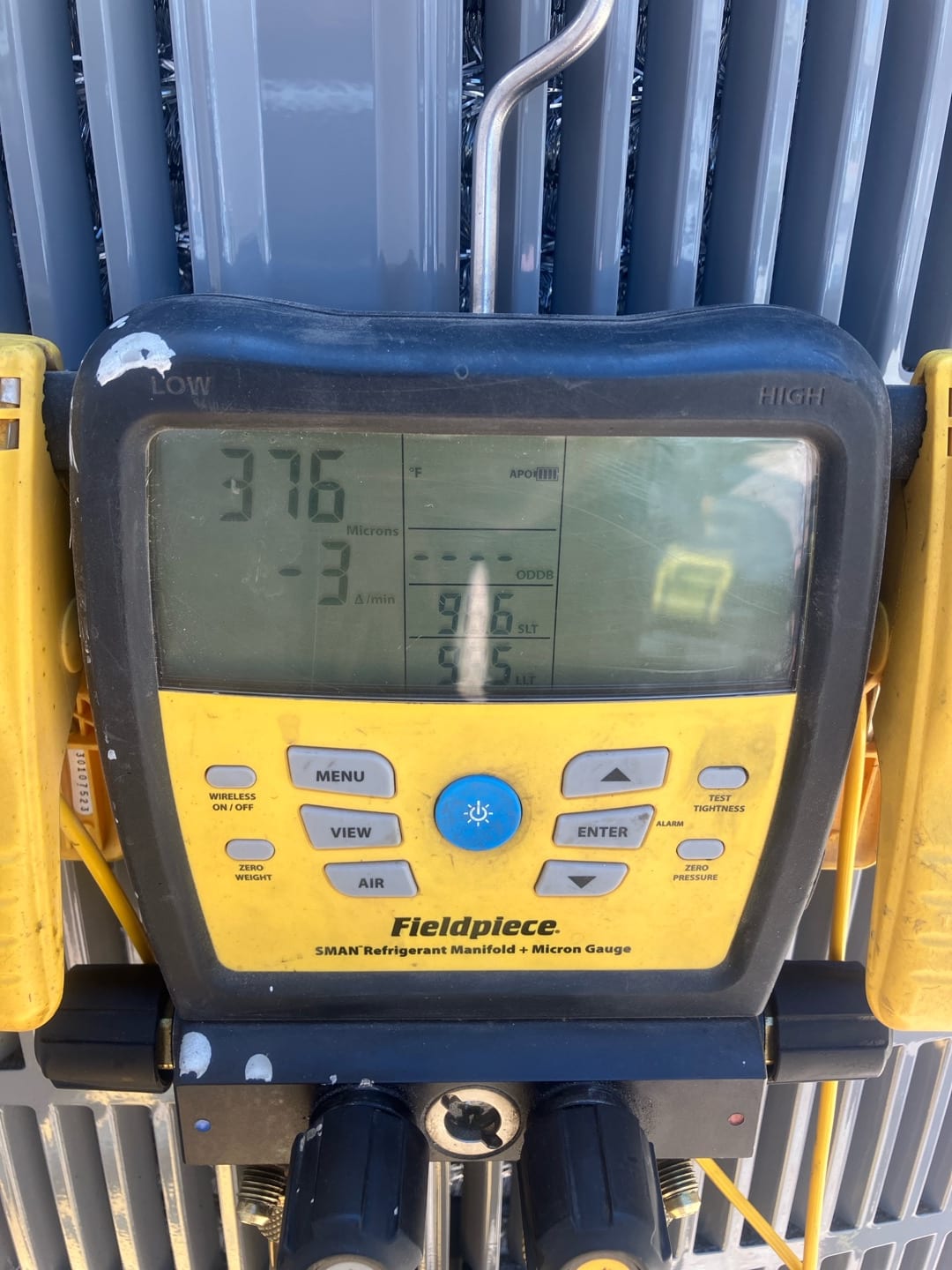 Digital manifold gauges show equalized pressure at 376 PSI on both sides during a nitrogen pressure test of the new system.