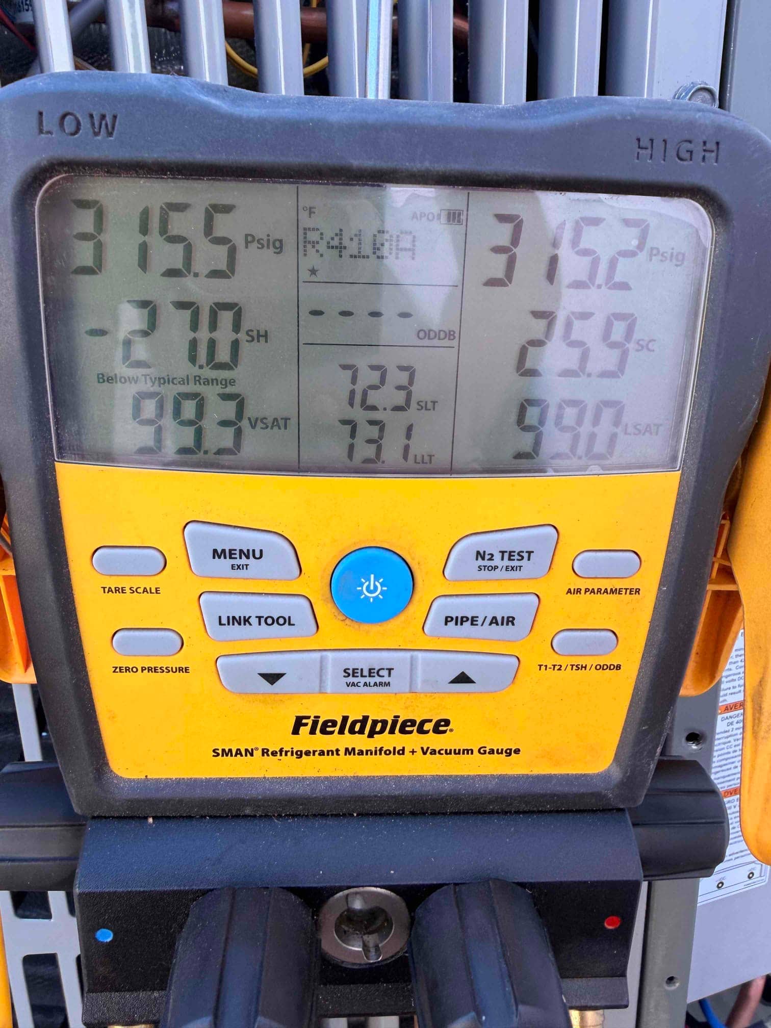 Digital manifold shows both high and low sides holding around 315 PSI during a nitrogen pressure test on the new system.