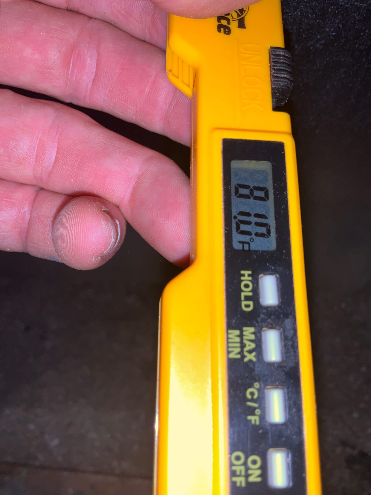 Digital thermometer displays 81.0°F while checking air temperature during HVAC commissioning.