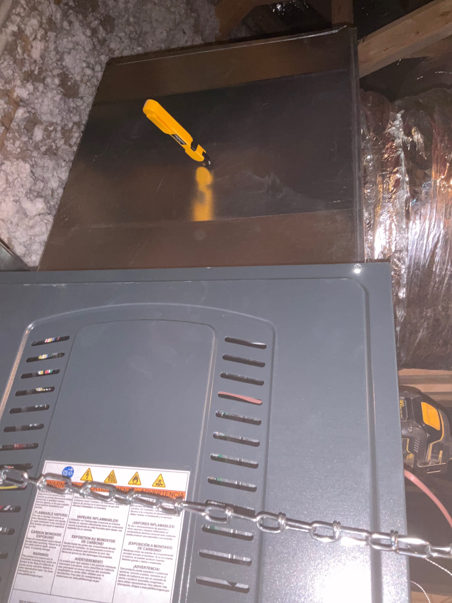 Suspended attic air handler with sealed sheet-metal plenum and insulated flex duct connection visible during installation.