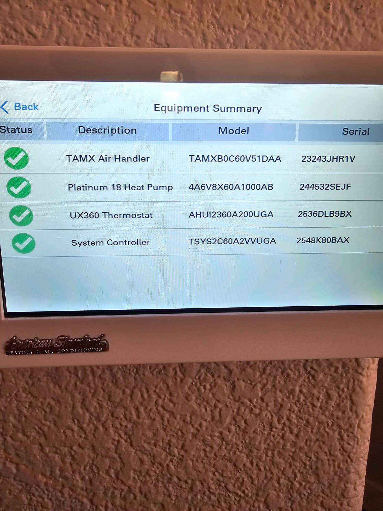 Thermostat touchscreen displays equipment summary with connected air handler, heat pump, thermostat, and system controller listed and checked.