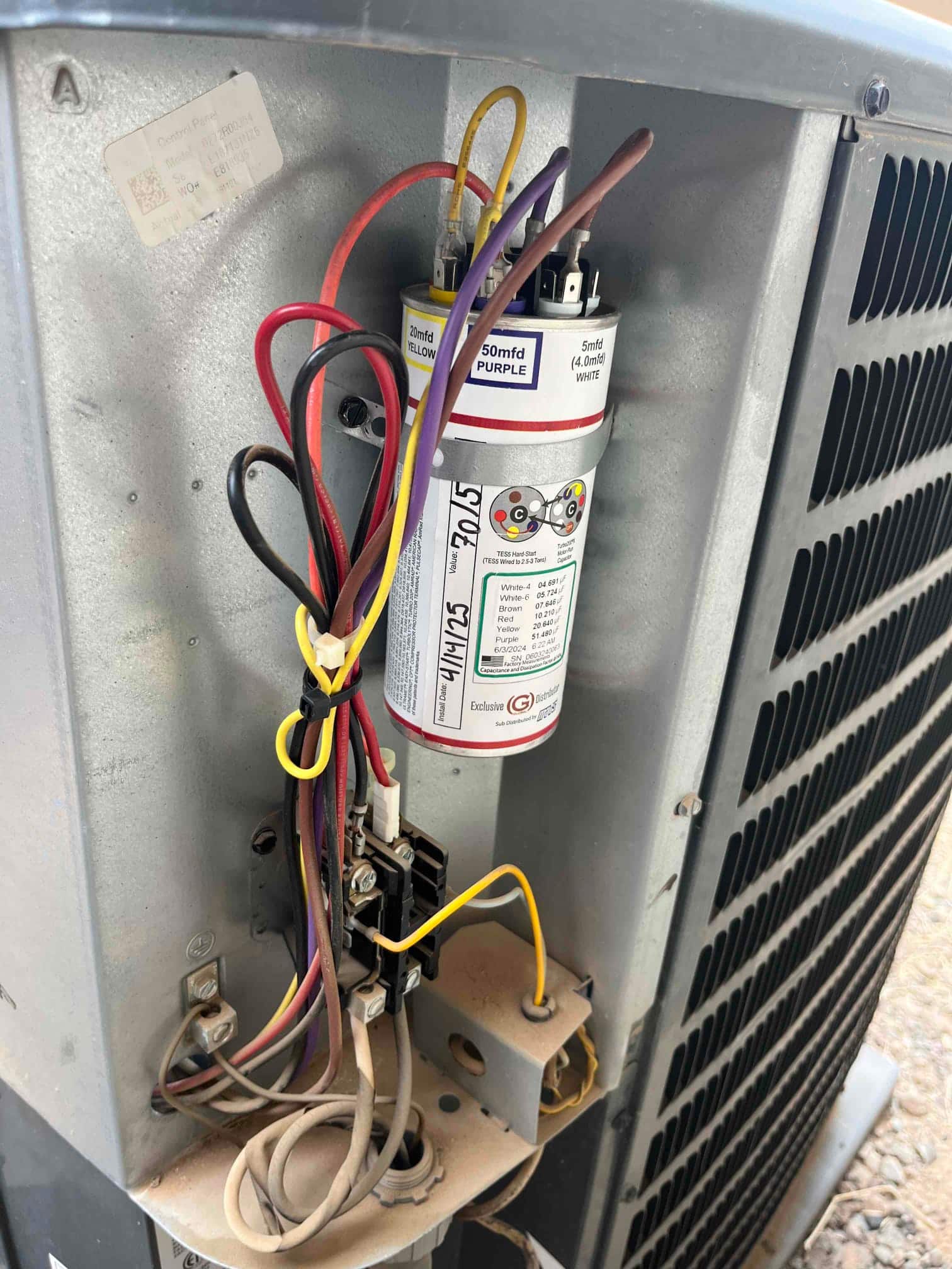 Turbo 200x run capacitor installed inside outdoor condenser, with connected wires and contactor visible in the electrical compartment.
