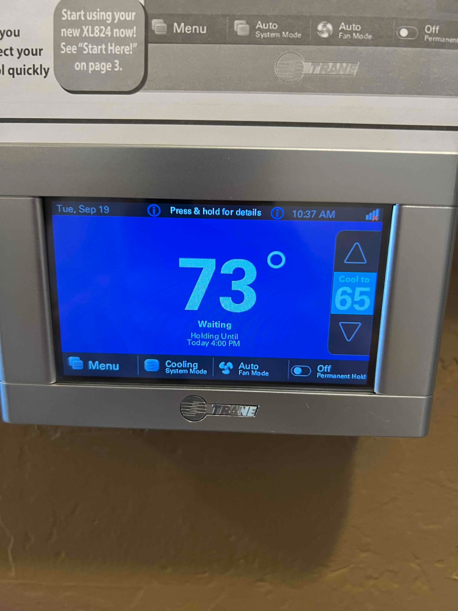 Wall-mounted touchscreen thermostat displays 73 degrees with system in cooling mode and setpoint shown on the right.