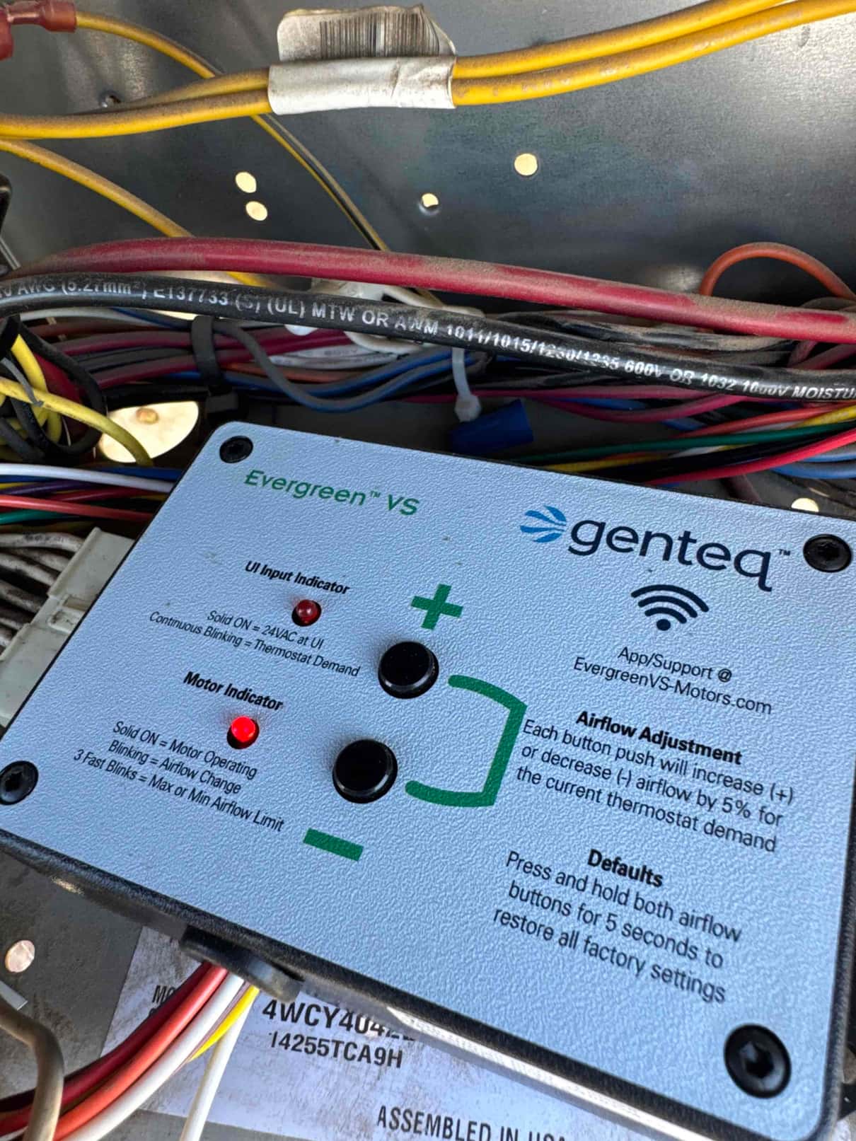 Evergreen VS variable-speed indoor blower motor control module installed in the air handler, with wiring harnesses connected and adjustment buttons visible.