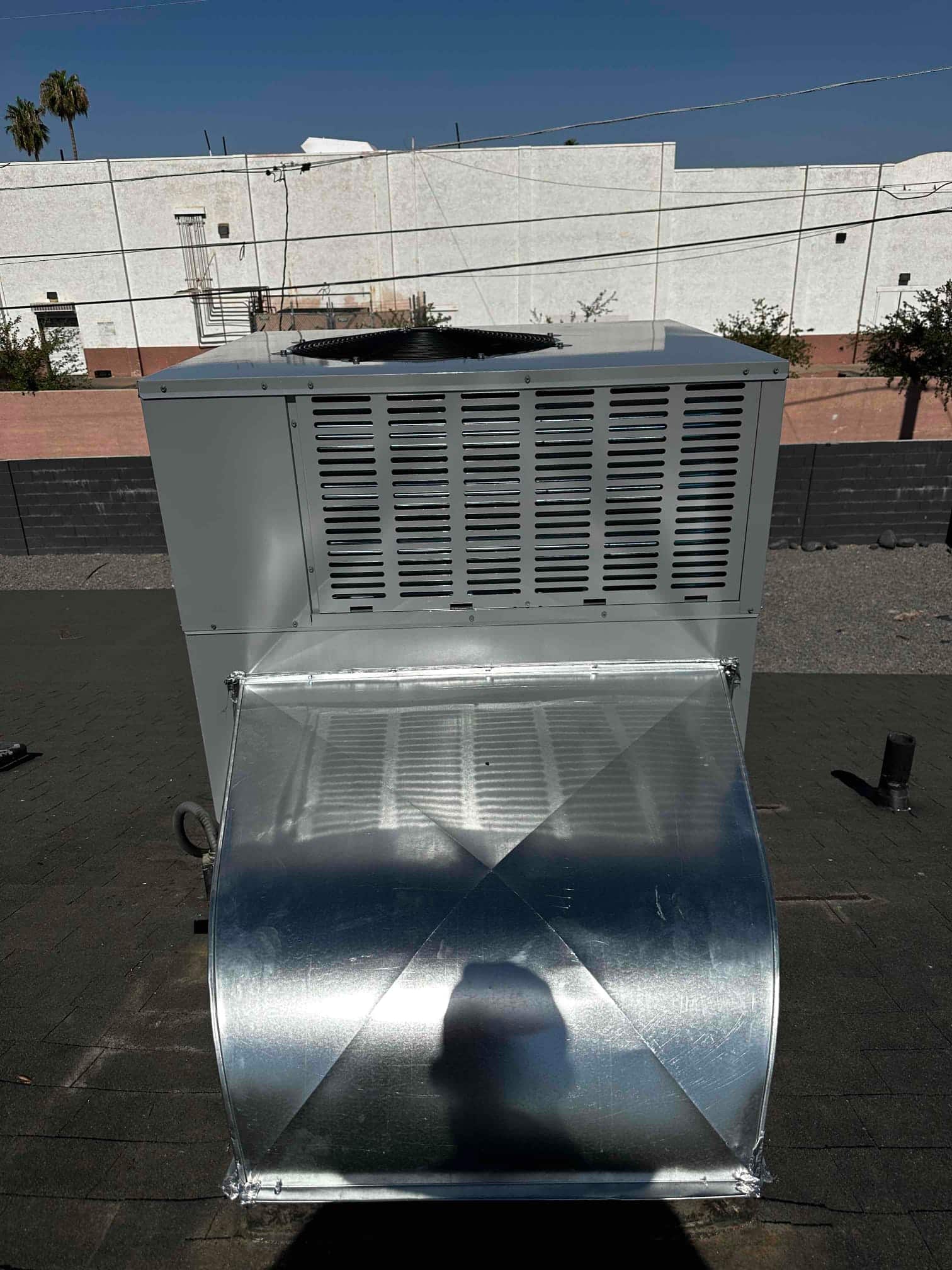 Rooftop packaged HVAC unit newly installed with sealed galvanized transition duct attached to the supply/return opening.