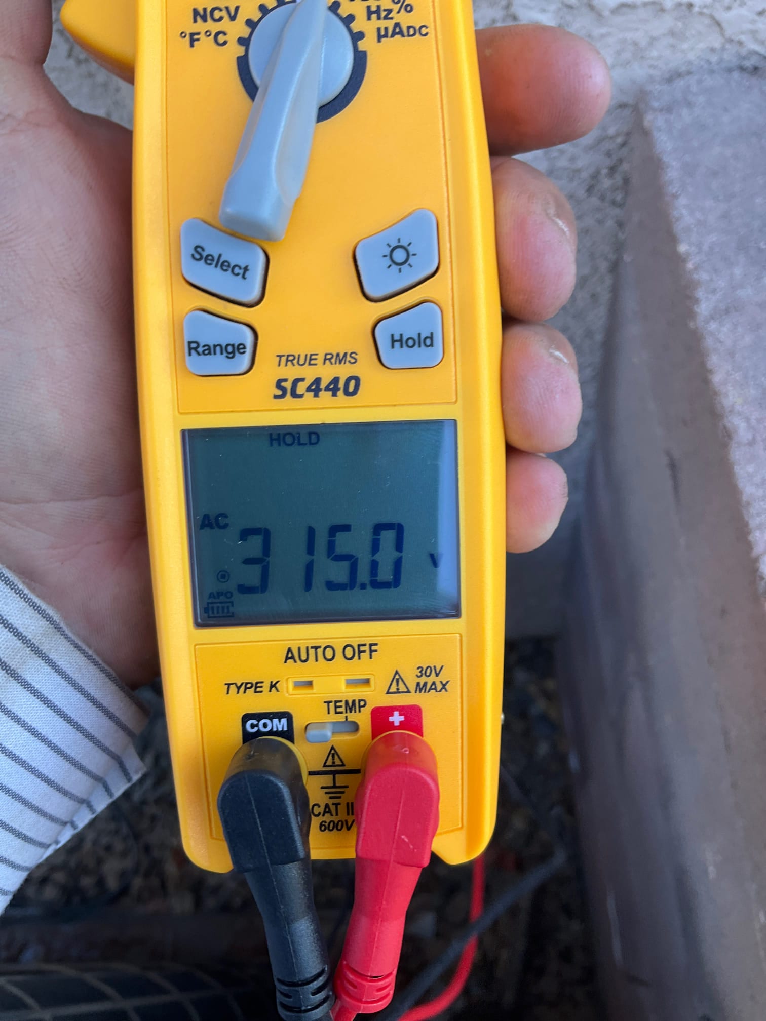 Diagnostic instrument display shows 315 V.