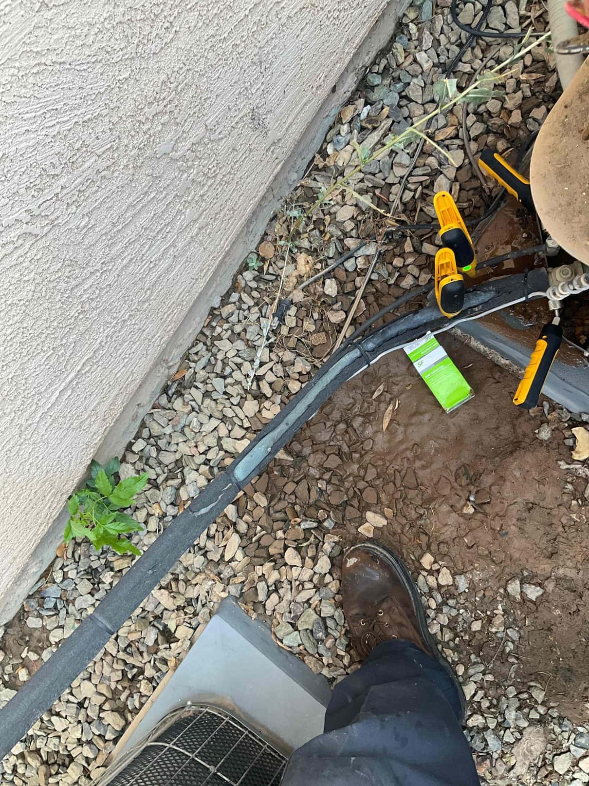 Insulated refrigerant lines at outdoor condenser with two temperature clamp sensors attached near service area.