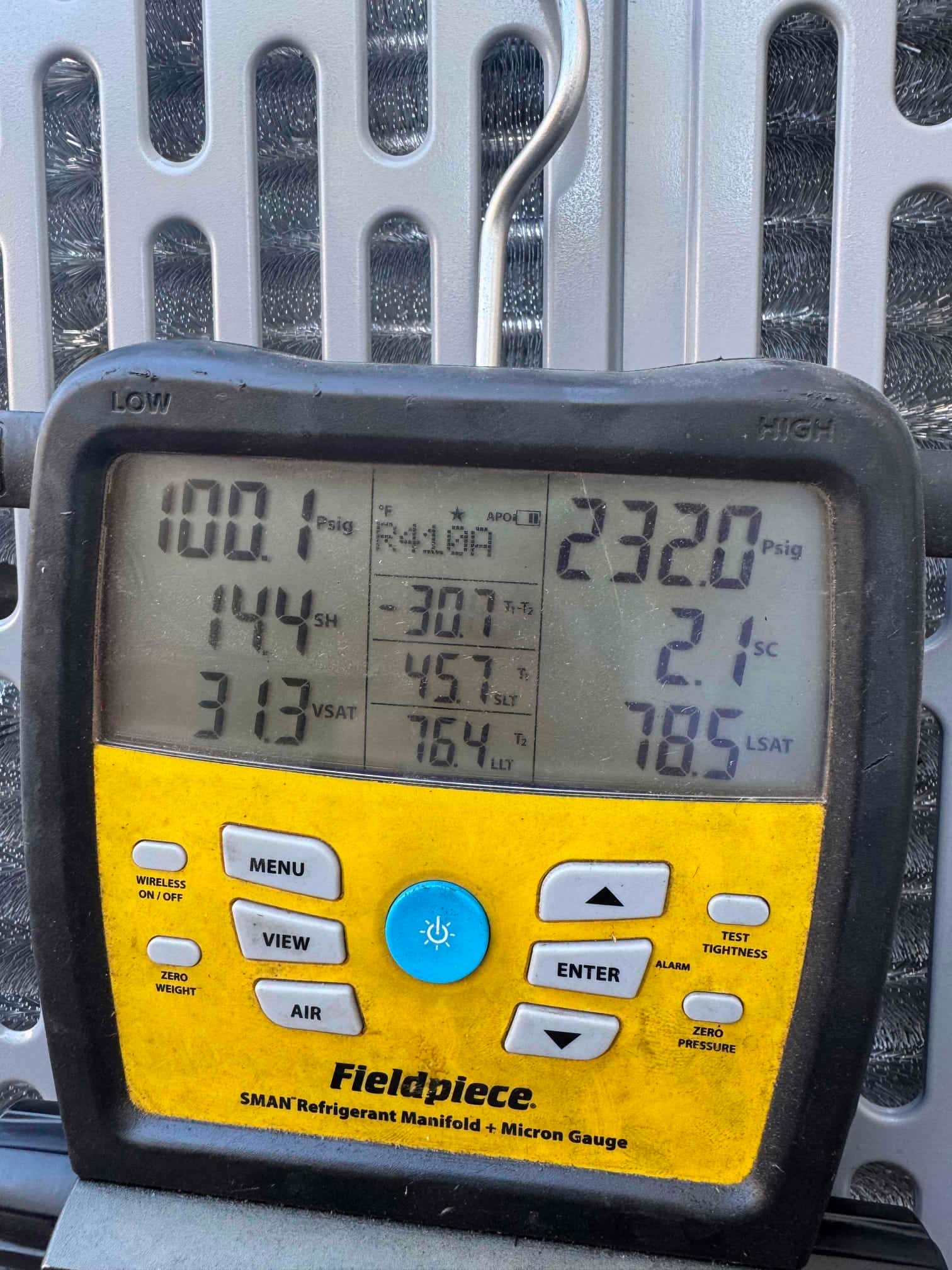 Digital manifold shows operating pressures with R-410A selected: low side 100 psig and high side 232 psig during system run.