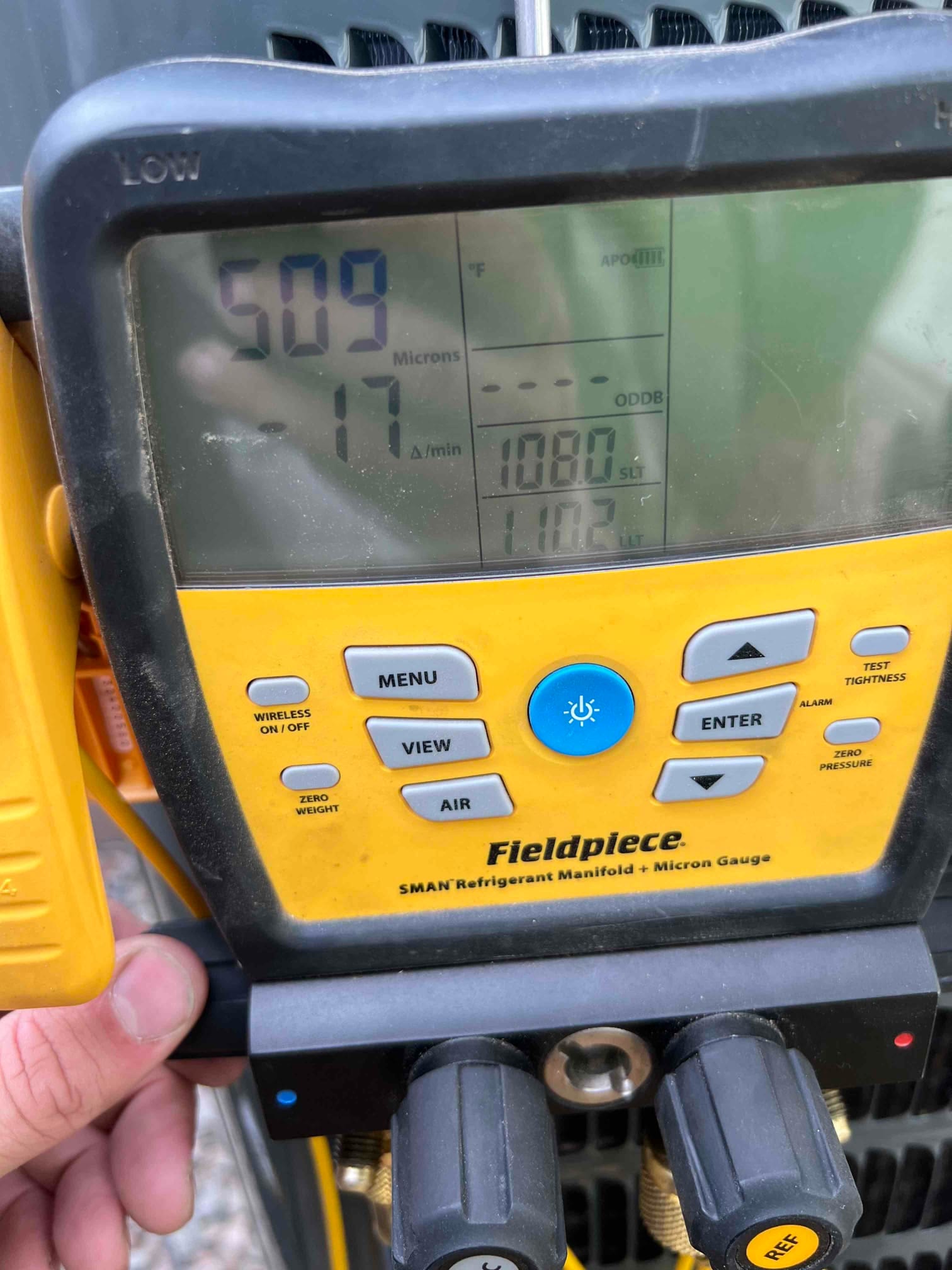 Digital micron gauge on the manifold shows 509 microns during evacuation of the newly installed system.