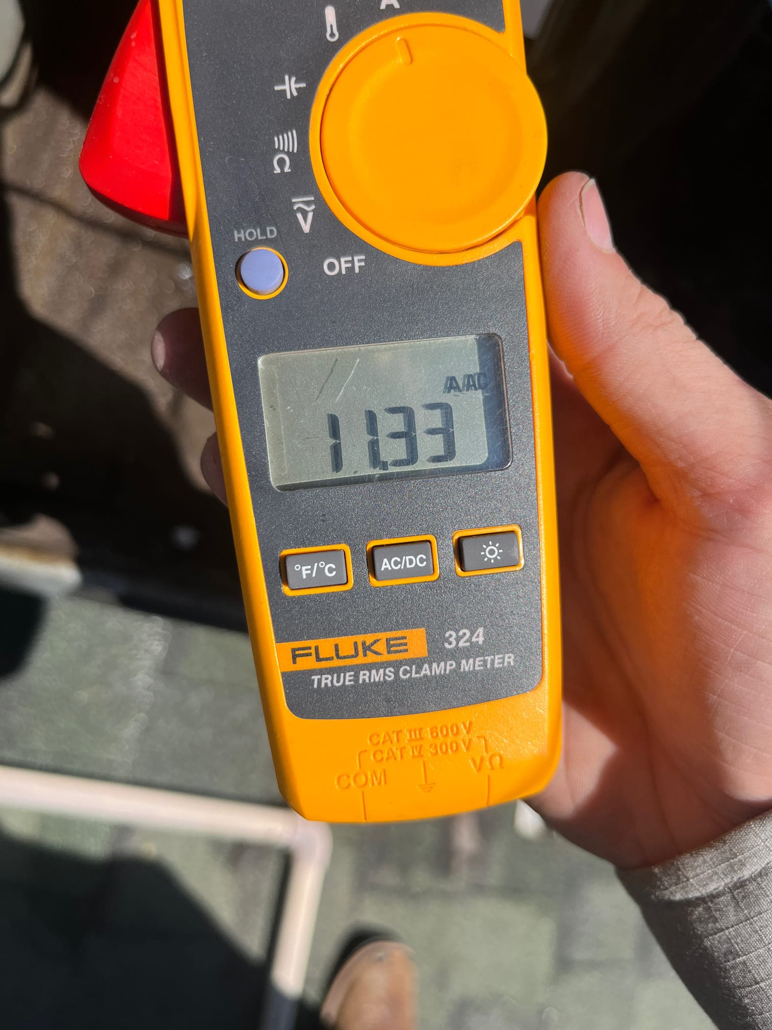 Clamp meter displays 11.33 A on the selected current range during HVAC system testing.