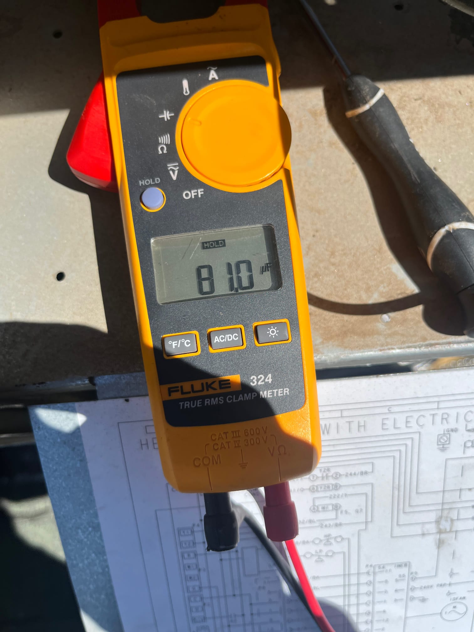 Clamp meter temperature function shows 81.0 °F on the display during air conditioning diagnostic testing.