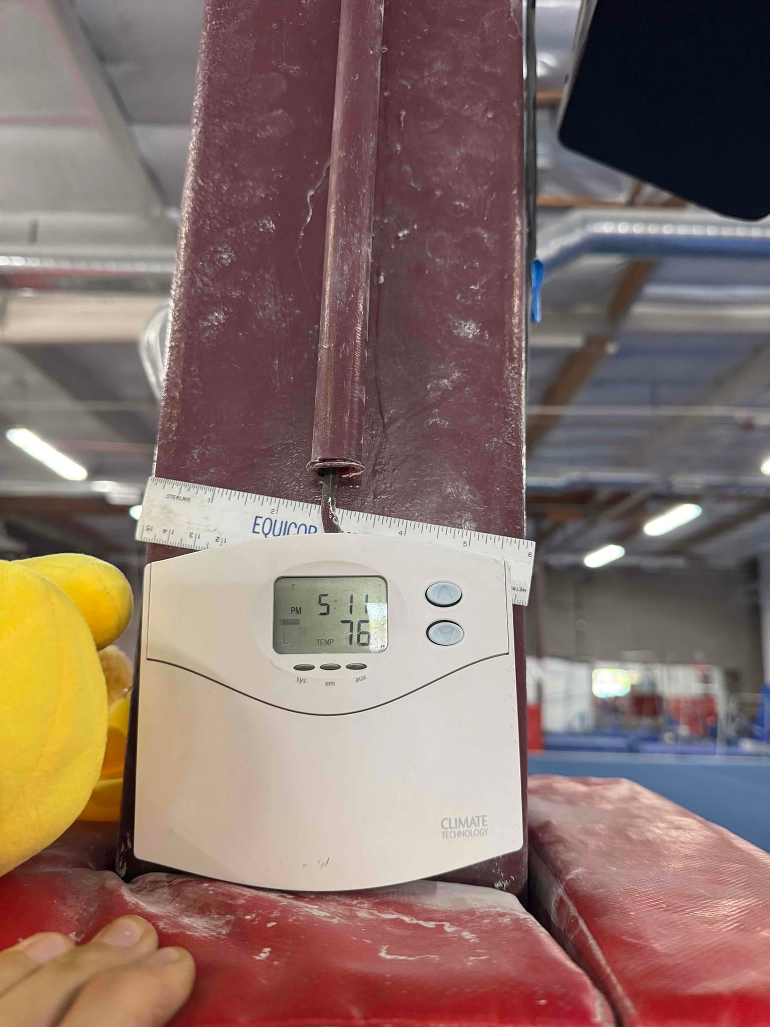 Digital thermostat display shows room temperature at 76°F with system setpoint at 51°F in a commercial space.