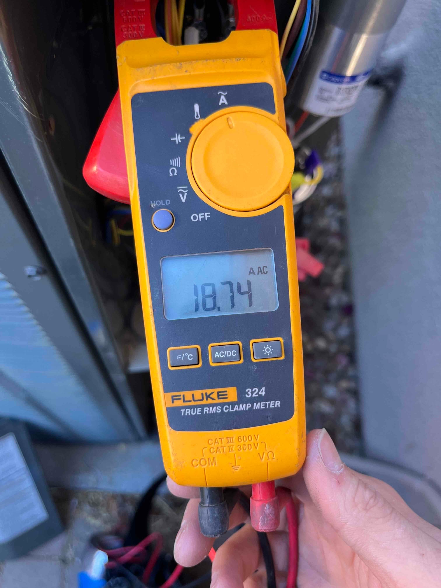 Diagnostic instrument display shows 18.74 A.