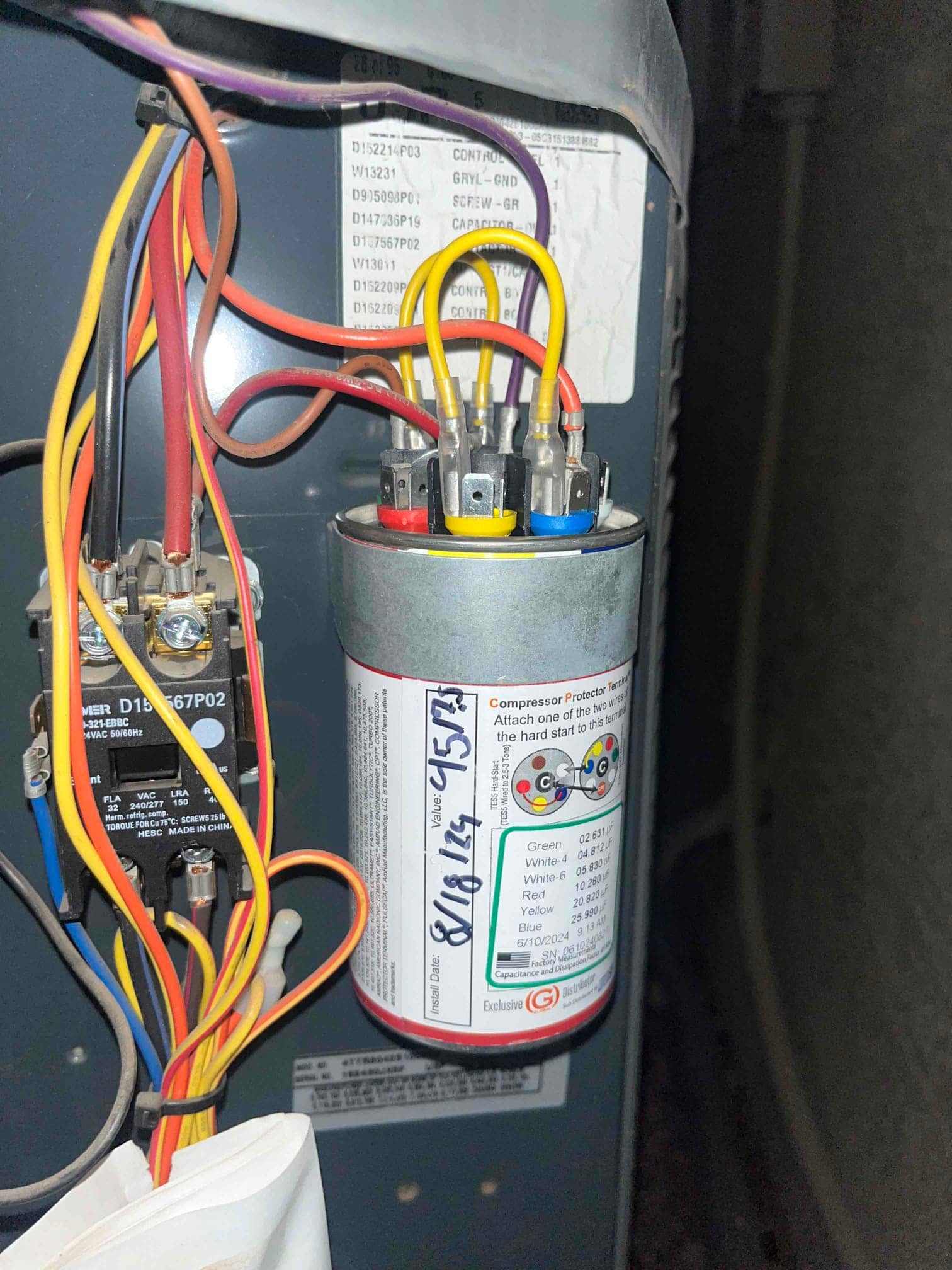 Dual-run capacitor mounted in the condenser cabinet with yellow, red, and blue wires connected to labeled terminals.