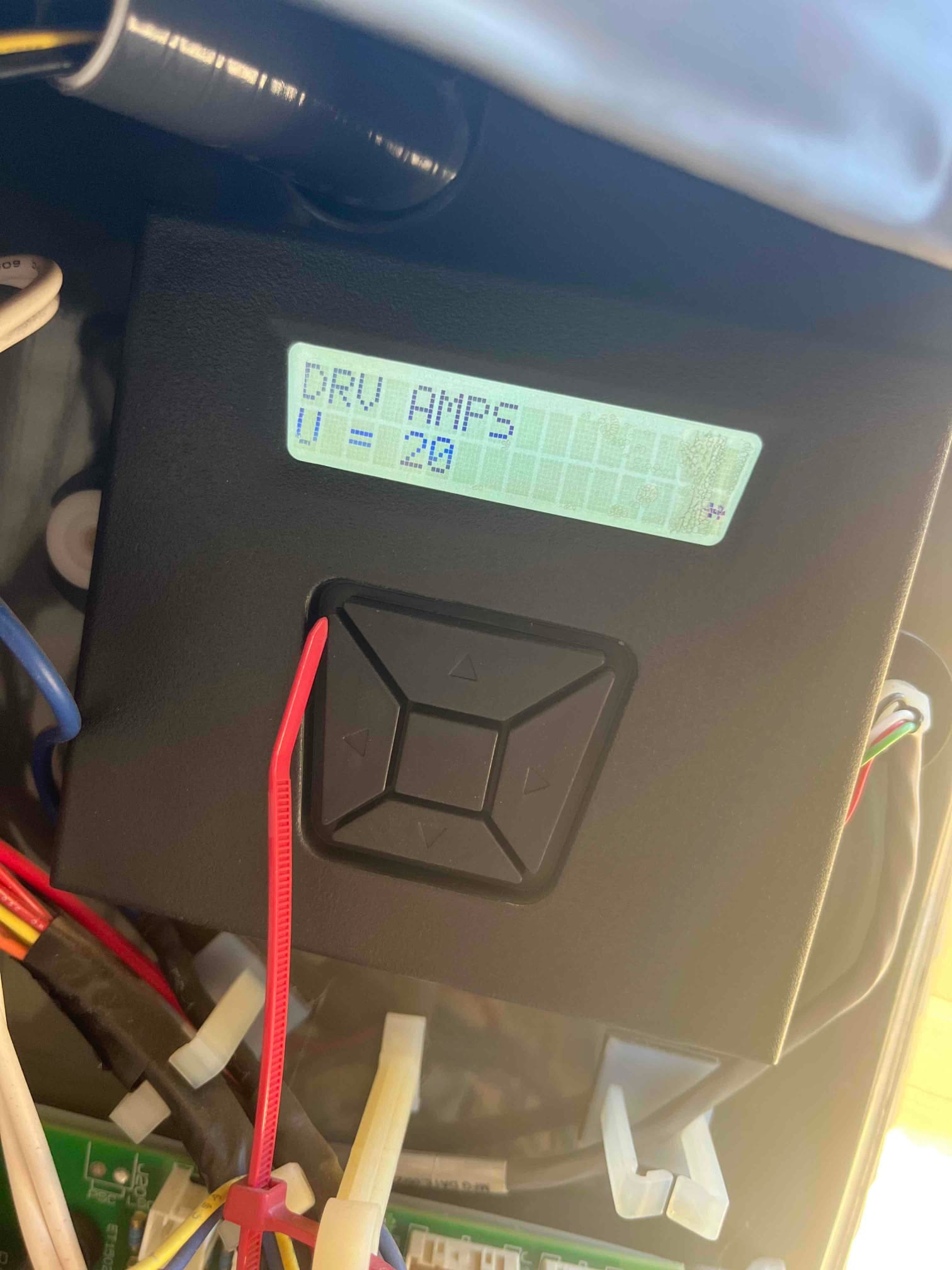 HVAC control module with LCD showing 'DRV AMPS' and 'U = 2.9', mounted in the control compartment with multiple connected wiring harnesses.