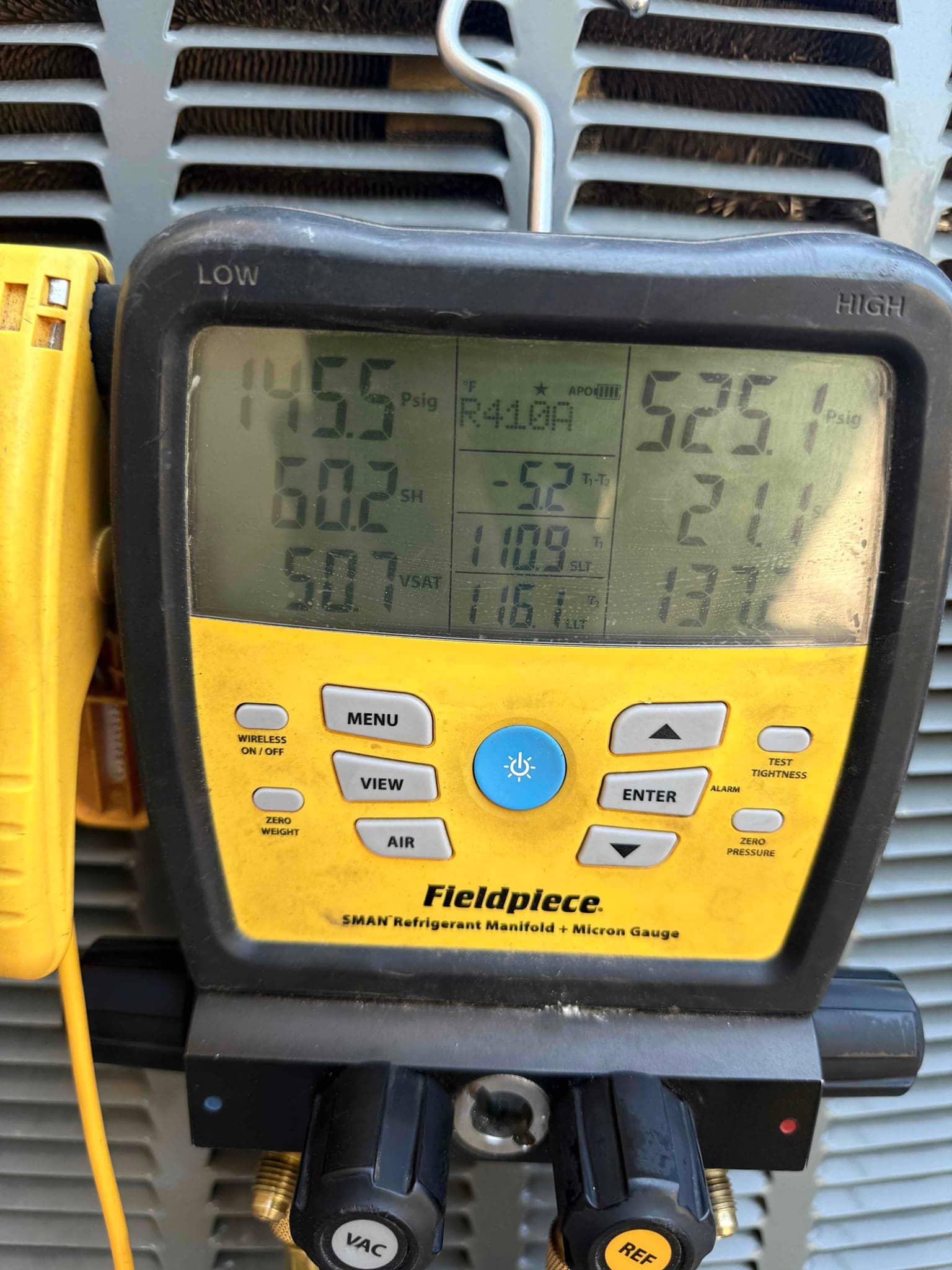 HVAC diagnostic instrument photographed during the service visit.