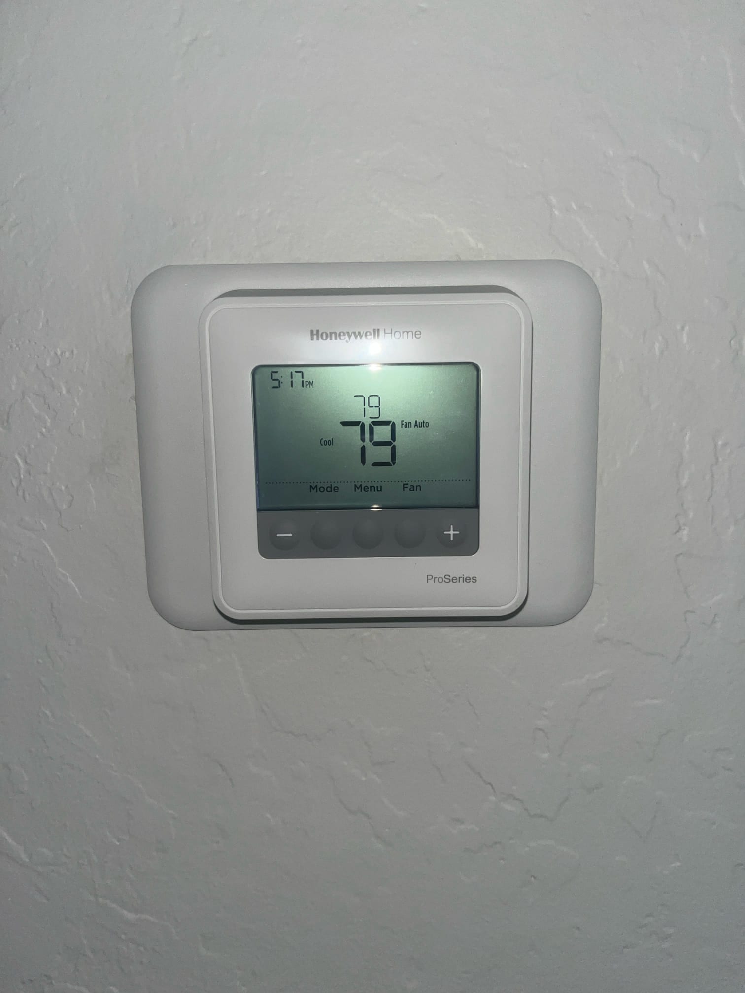 Wall-mounted digital thermostat displays 79°F room temperature and 78°F setpoint with cooling mode and fan auto.
