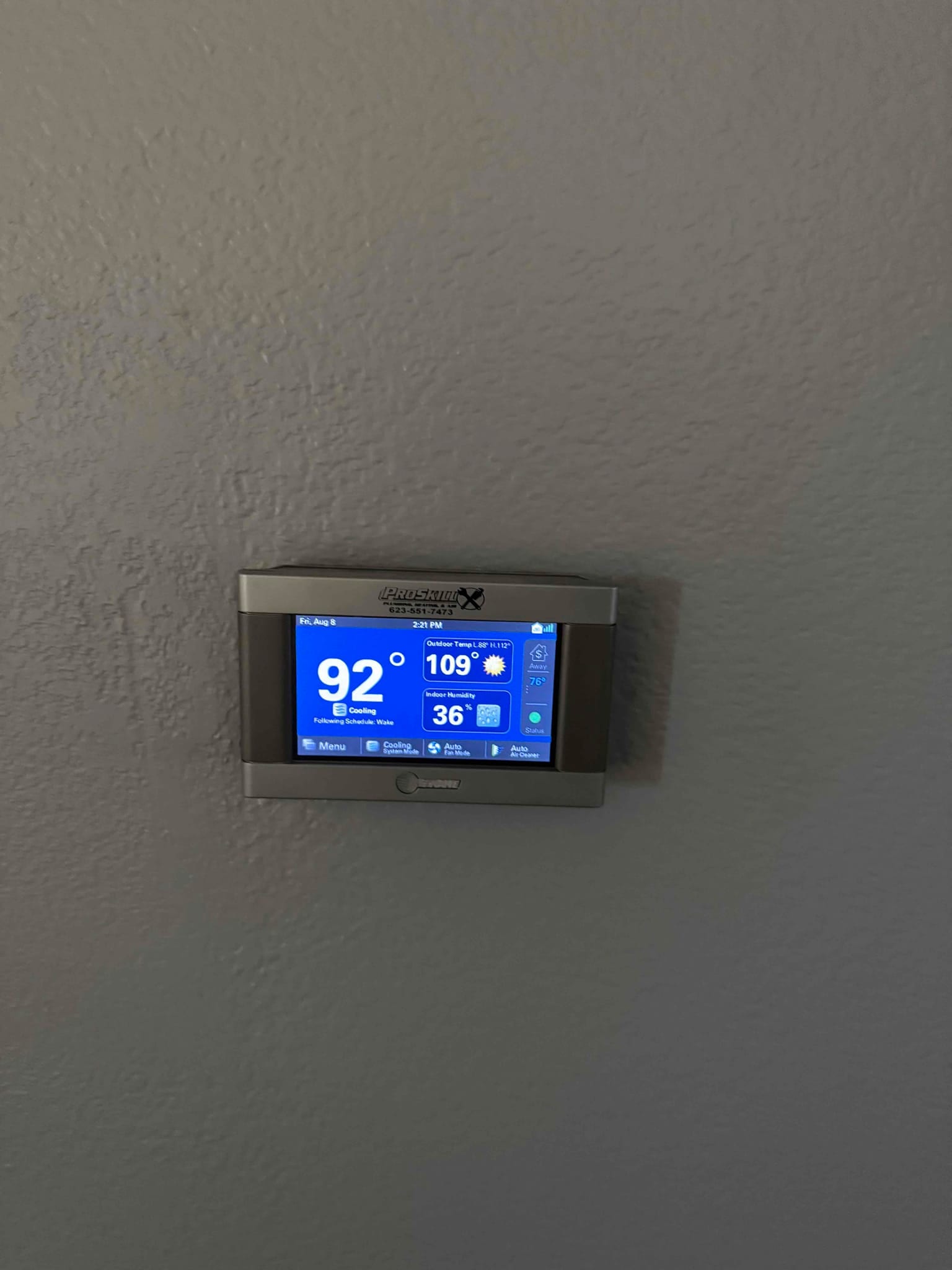 Wall-mounted digital thermostat displays indoor temperature 92°F, cooling mode active, and outdoor temperature 109°F with 36% indoor humidity.