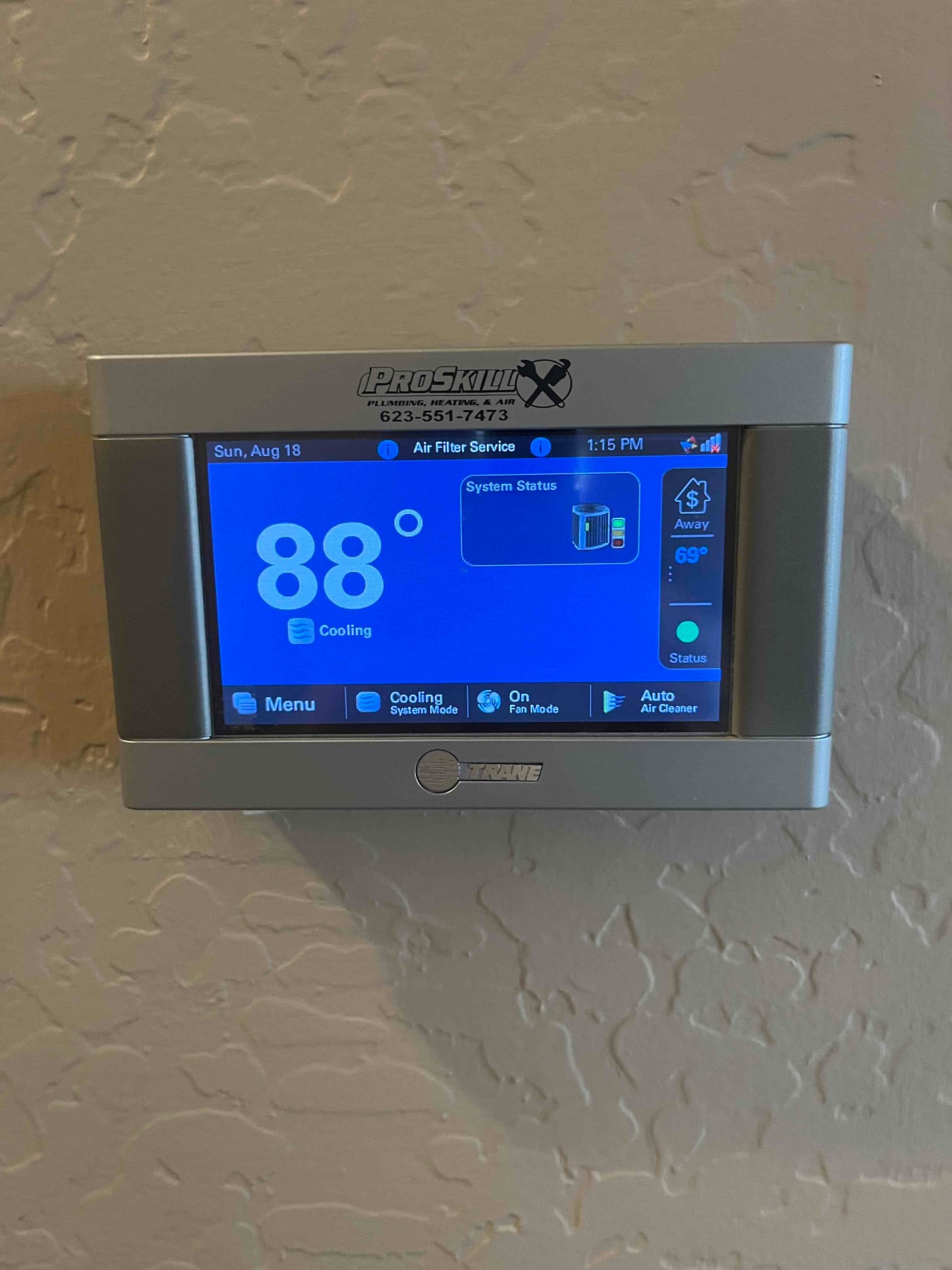Wall-mounted touchscreen thermostat displays 88° with cooling mode active and system status icons visible on the screen.