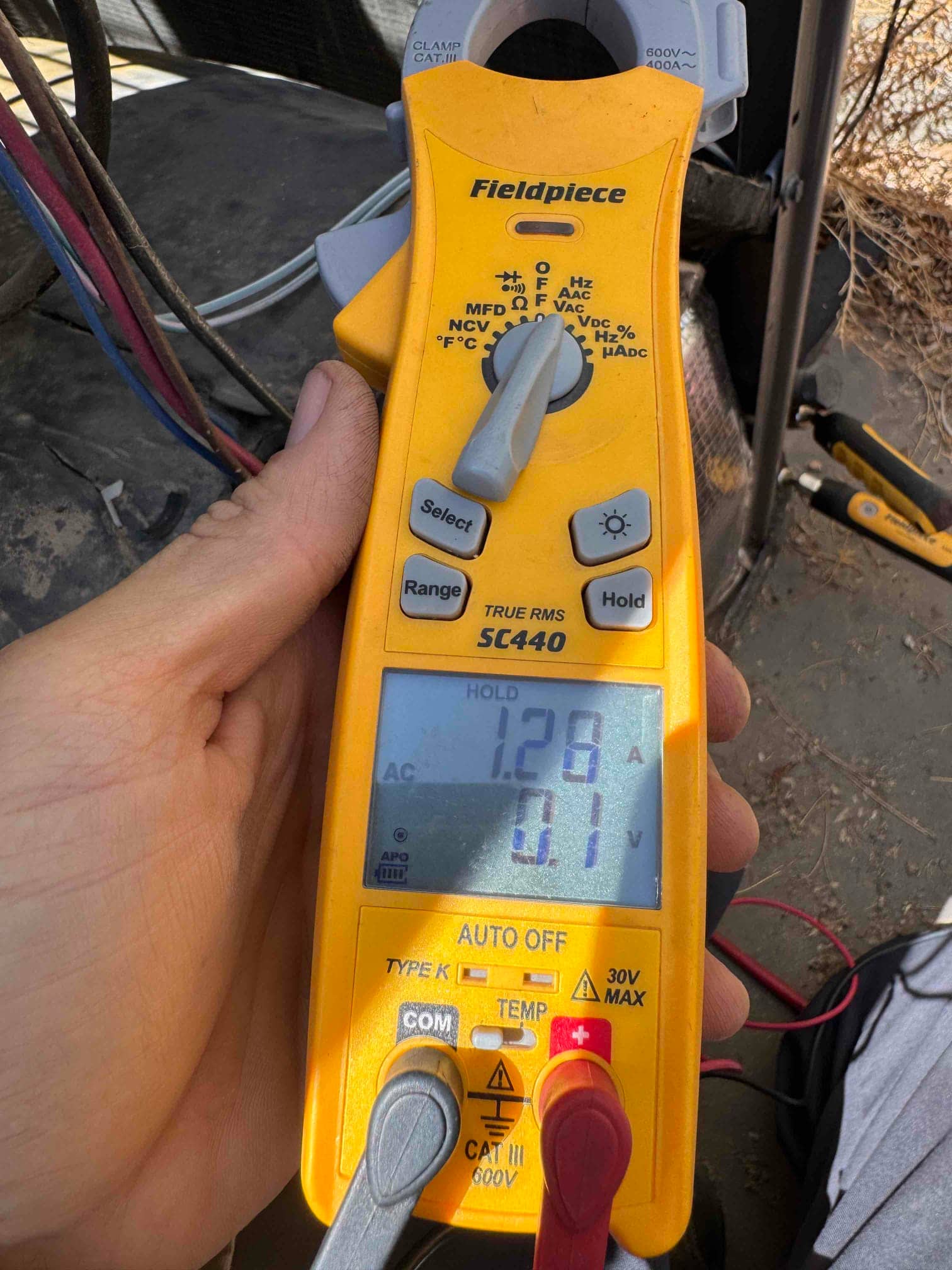 Diagnostic instrument display shows 1.28 A.