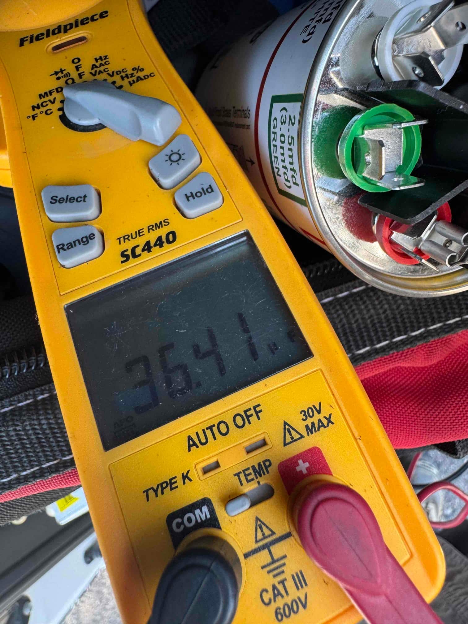 HVAC diagnostic instrument photographed during the service visit.