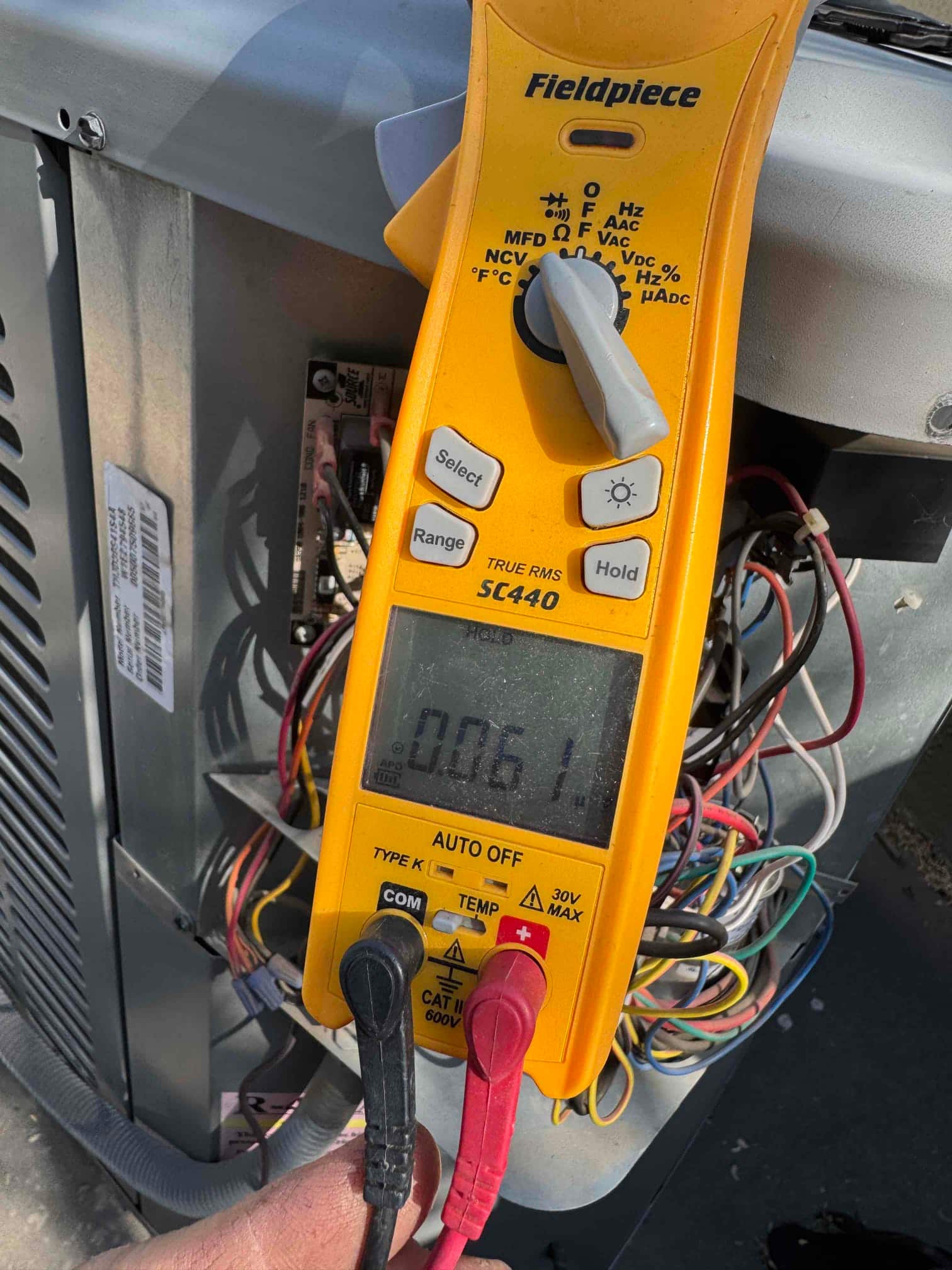 HVAC diagnostic instrument photographed during the service visit.