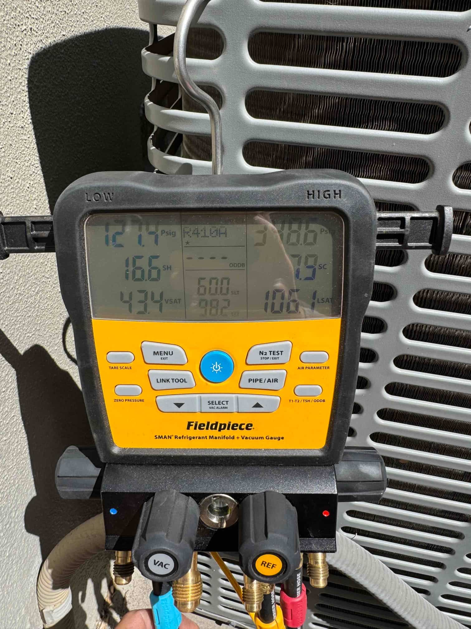 HVAC diagnostic instrument photographed during the service visit.