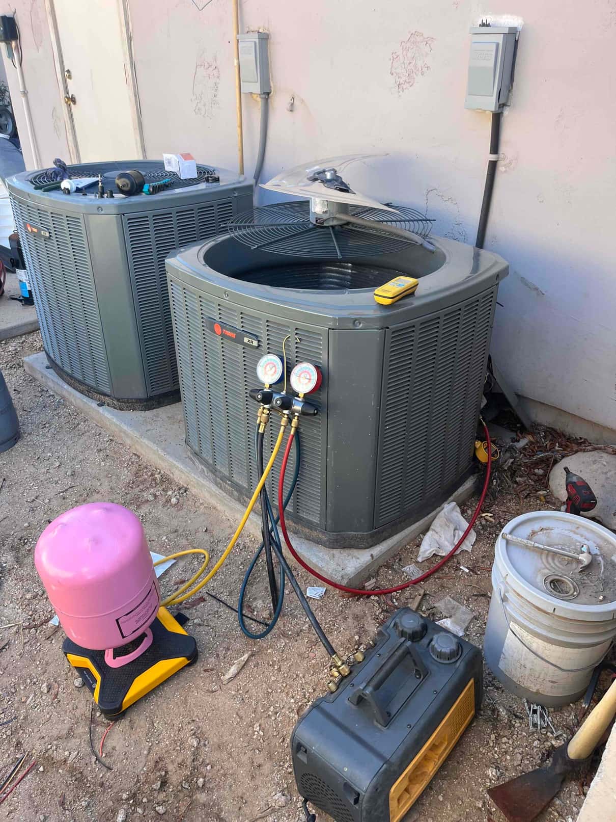 Refrigerant scale photographed during the service visit; no numerical reading is transcribed.