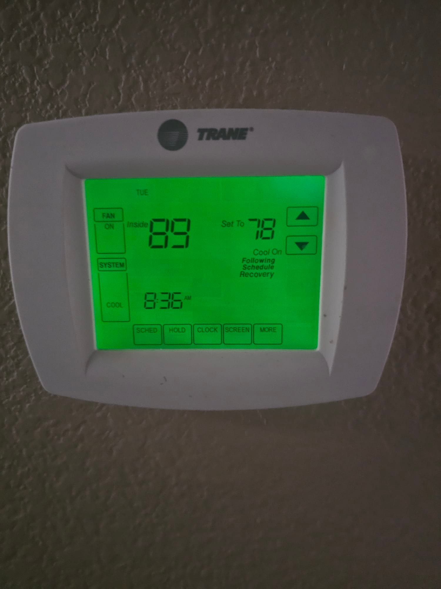 Wall-mounted thermostat shows inside 89 and setpoint 78 with cooling mode on and schedule recovery.