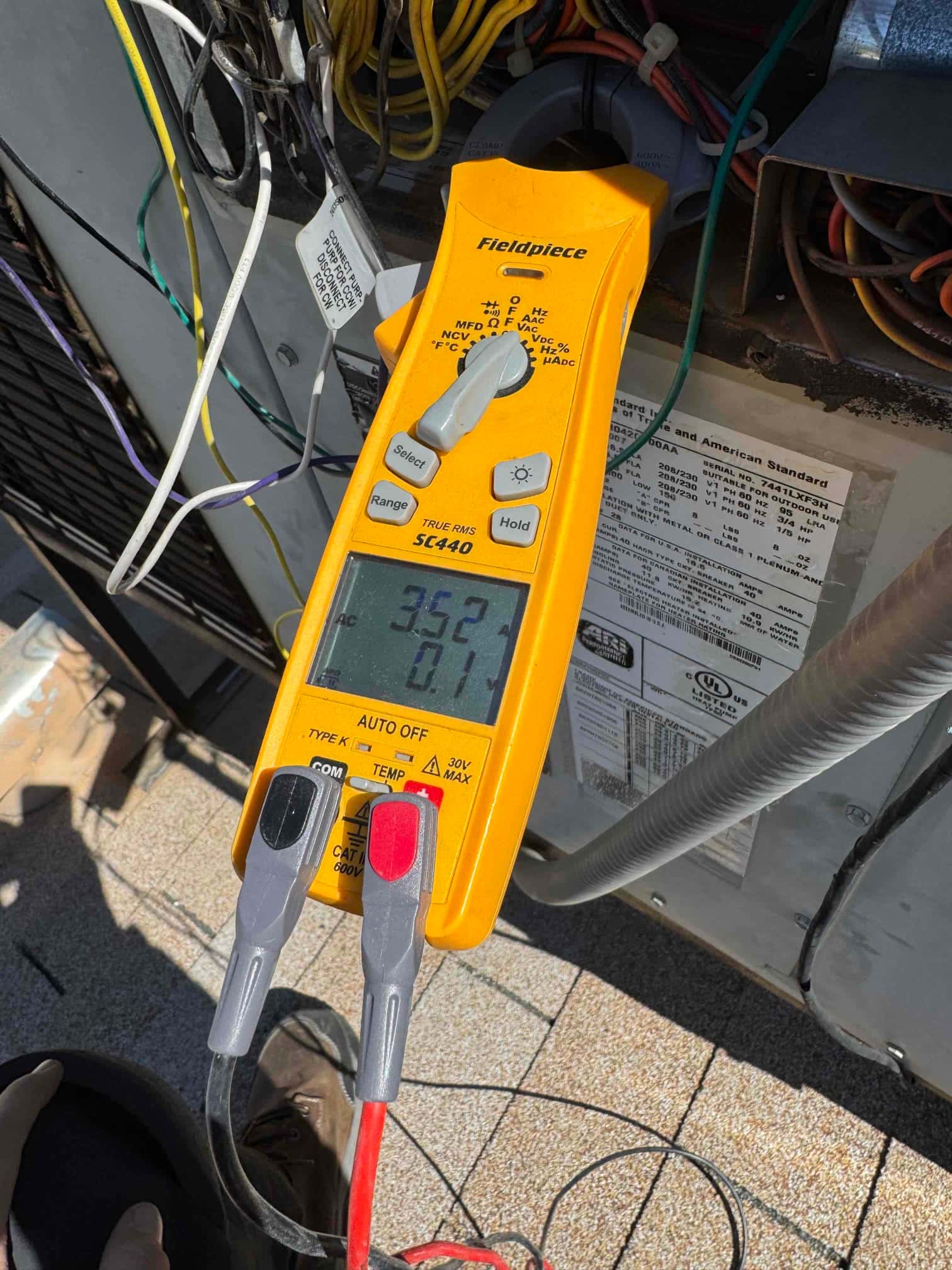 HVAC diagnostic instrument photographed during the service visit.