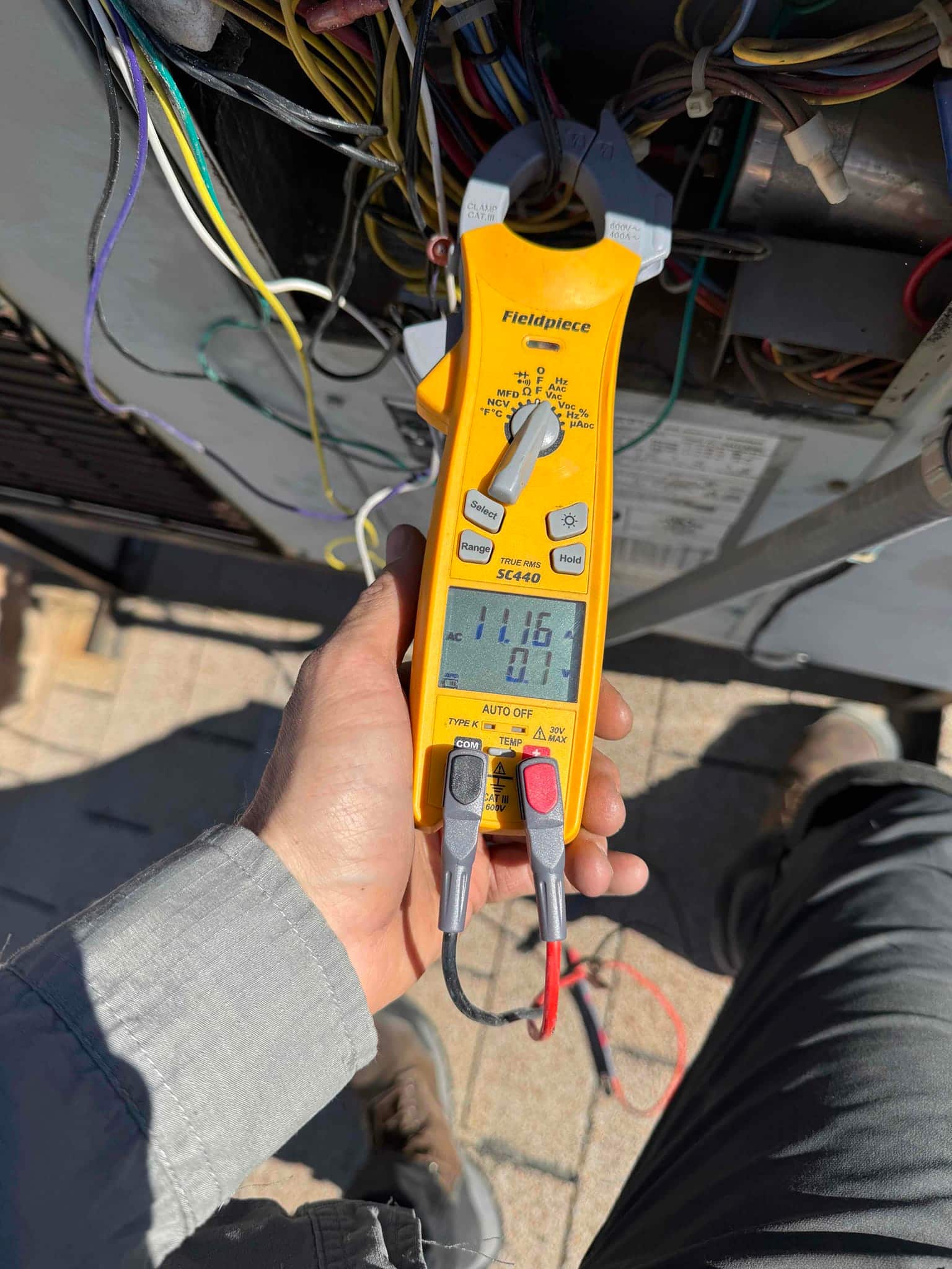 HVAC diagnostic instrument photographed during the service visit.