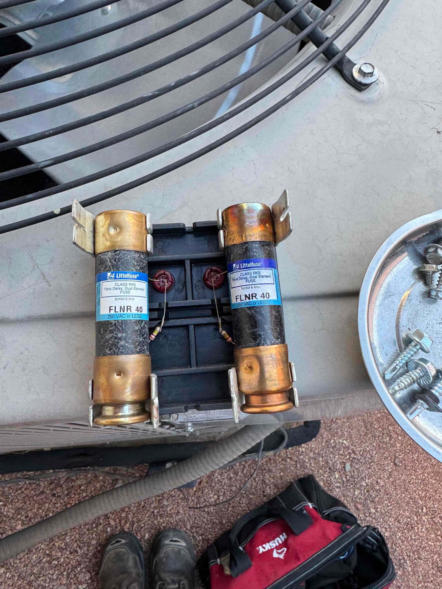 Two cartridge fuses set in a dual fuse holder on the outdoor condenser cover, labeled 40 A and 250 VAC.