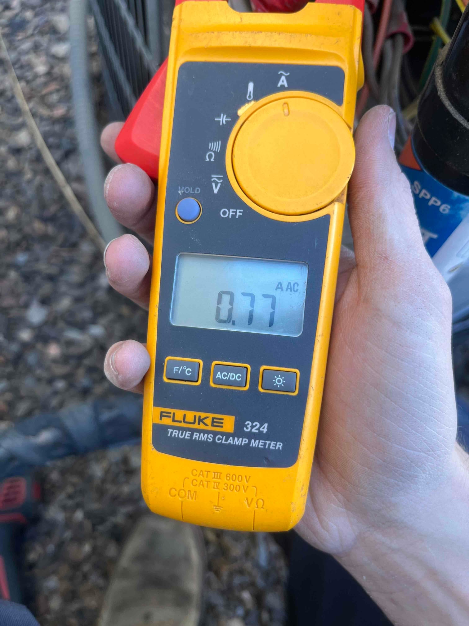 Diagnostic instrument display shows 0.77 A.