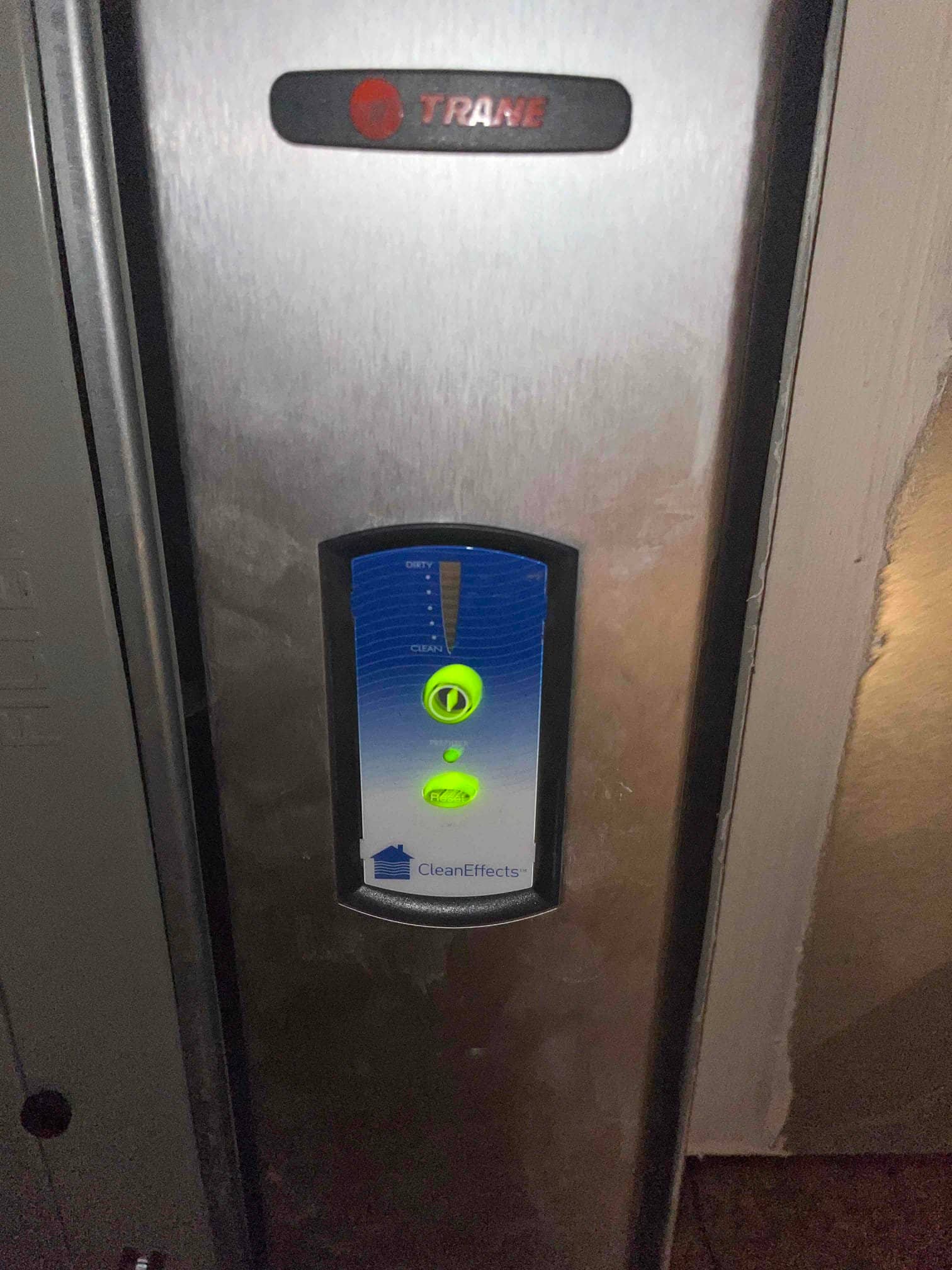 Electronic air cleaner cabinet panel with illuminated power and reset indicators and cleanliness level display.