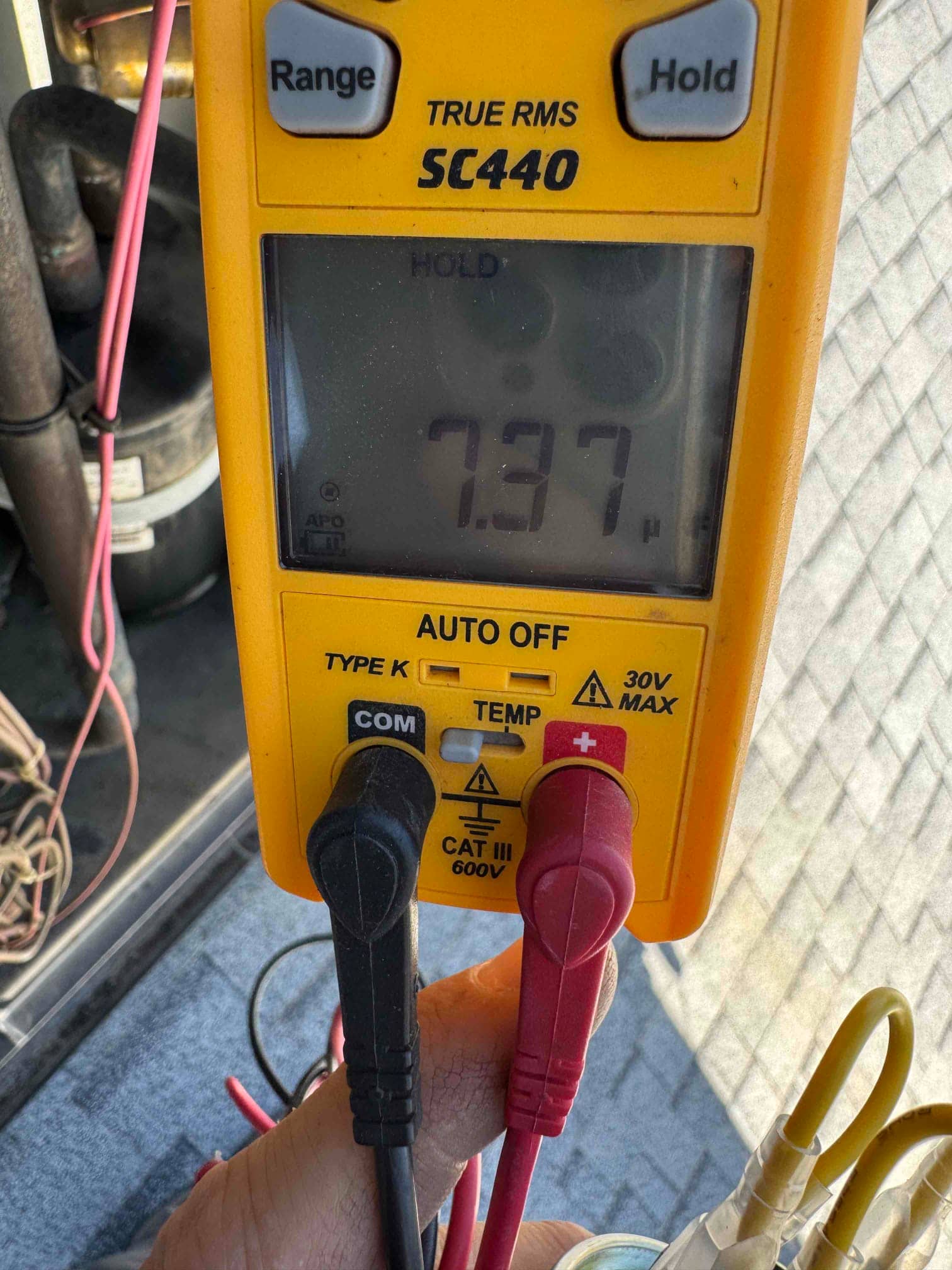 HVAC diagnostic instrument photographed during the service visit.