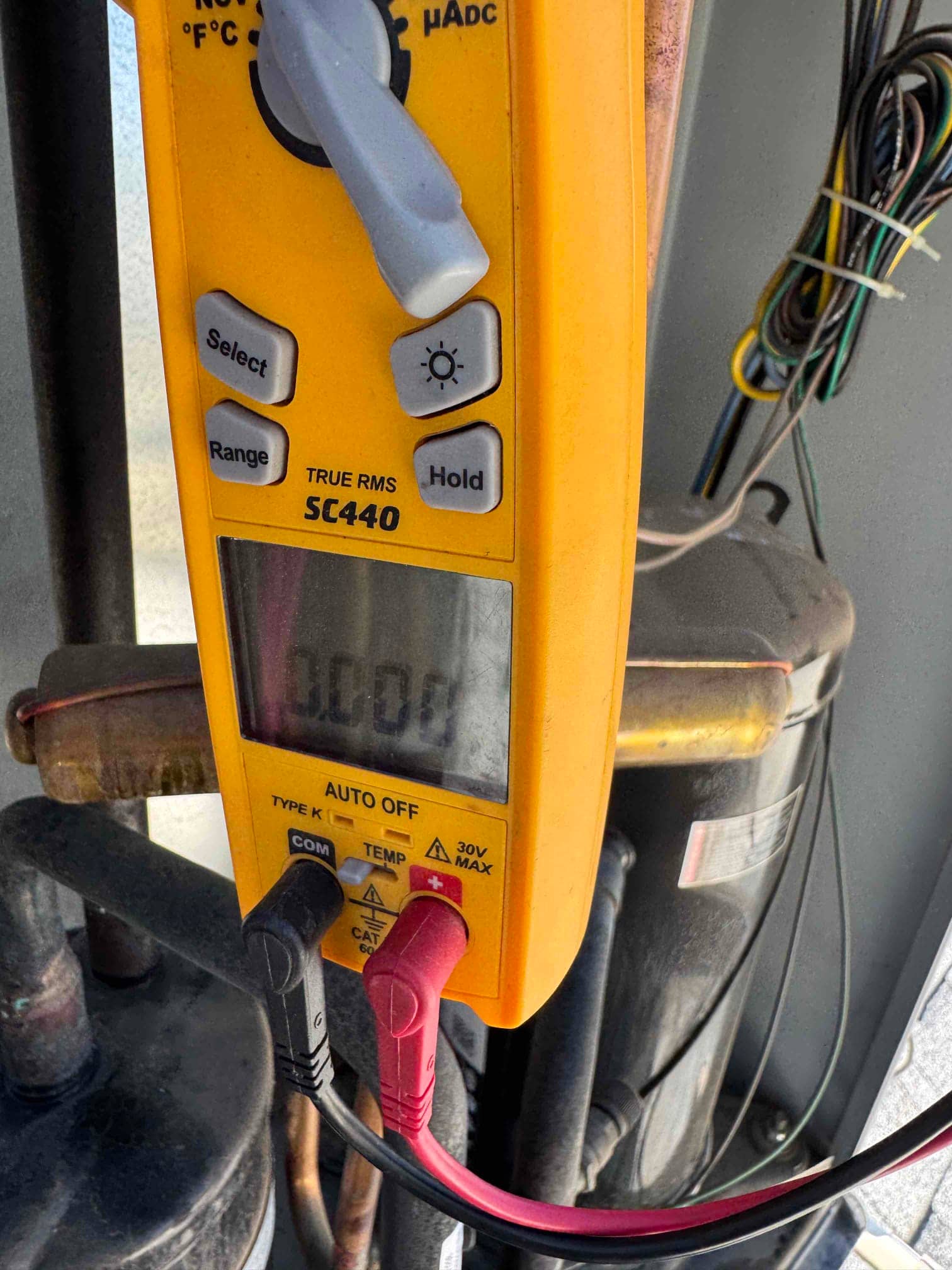 HVAC diagnostic instrument photographed during the service visit.