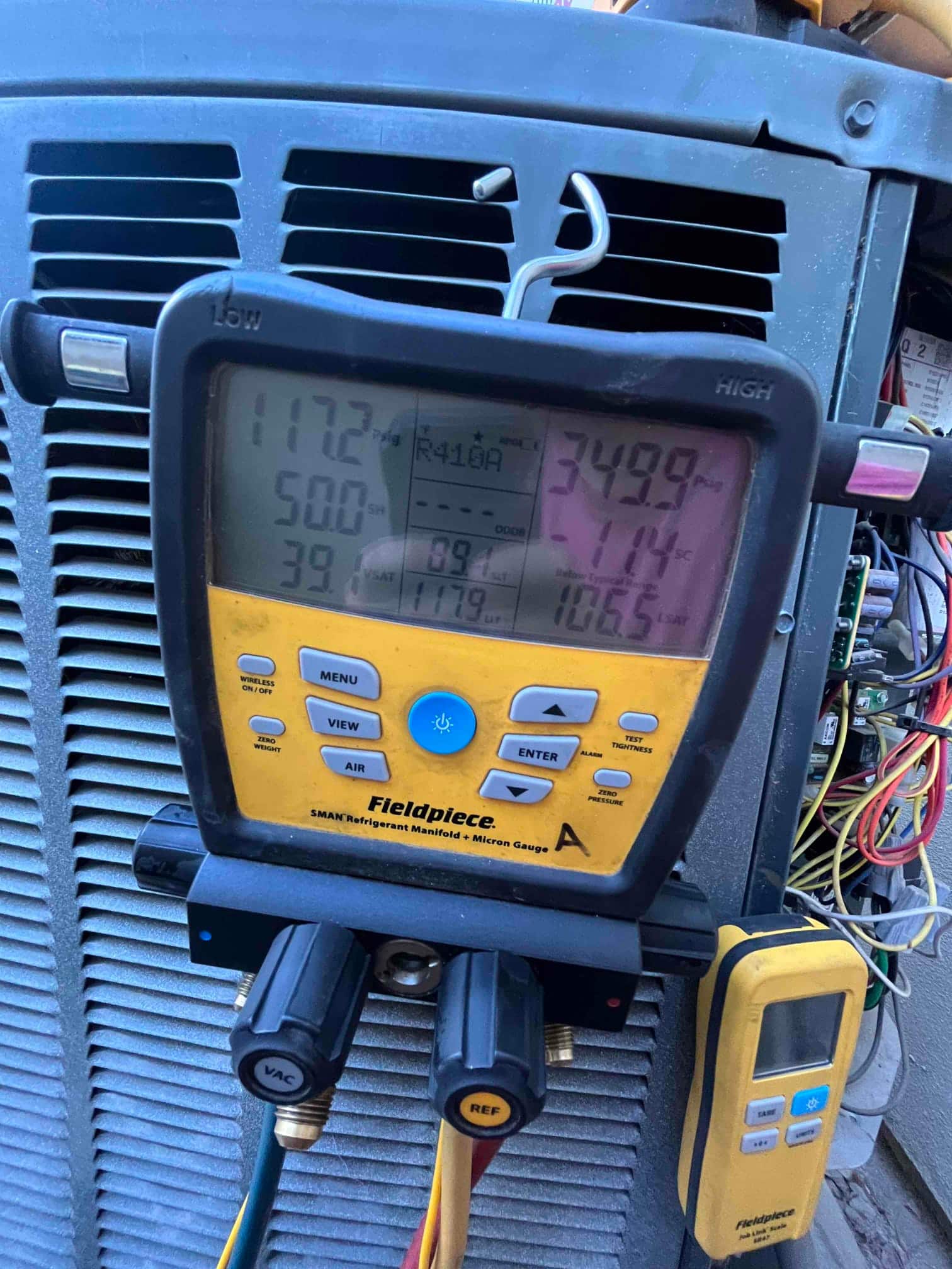 HVAC diagnostic instrument photographed during the service visit.