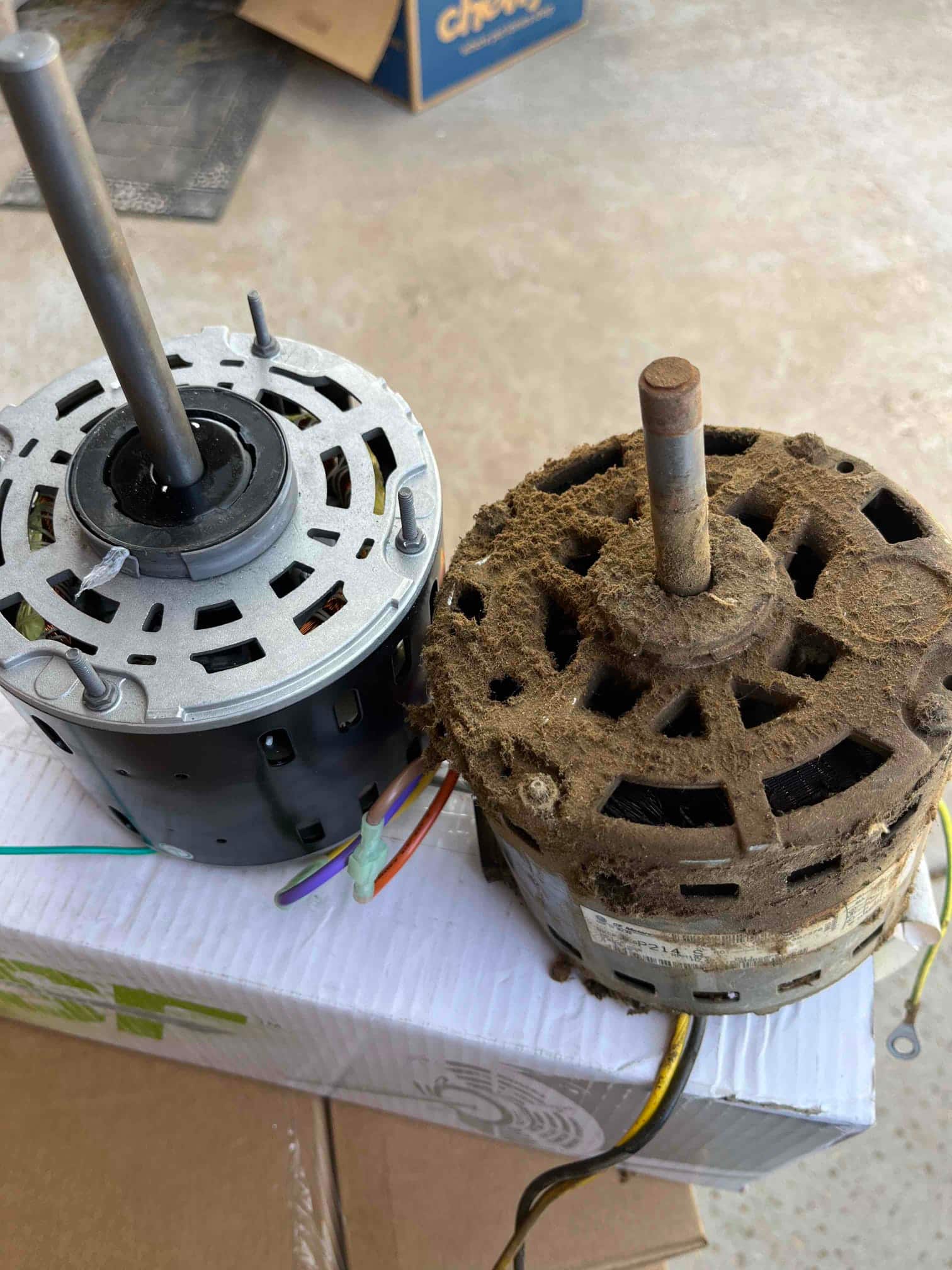 Two HVAC fan motors side by side, one clean and the other heavily dust-covered.