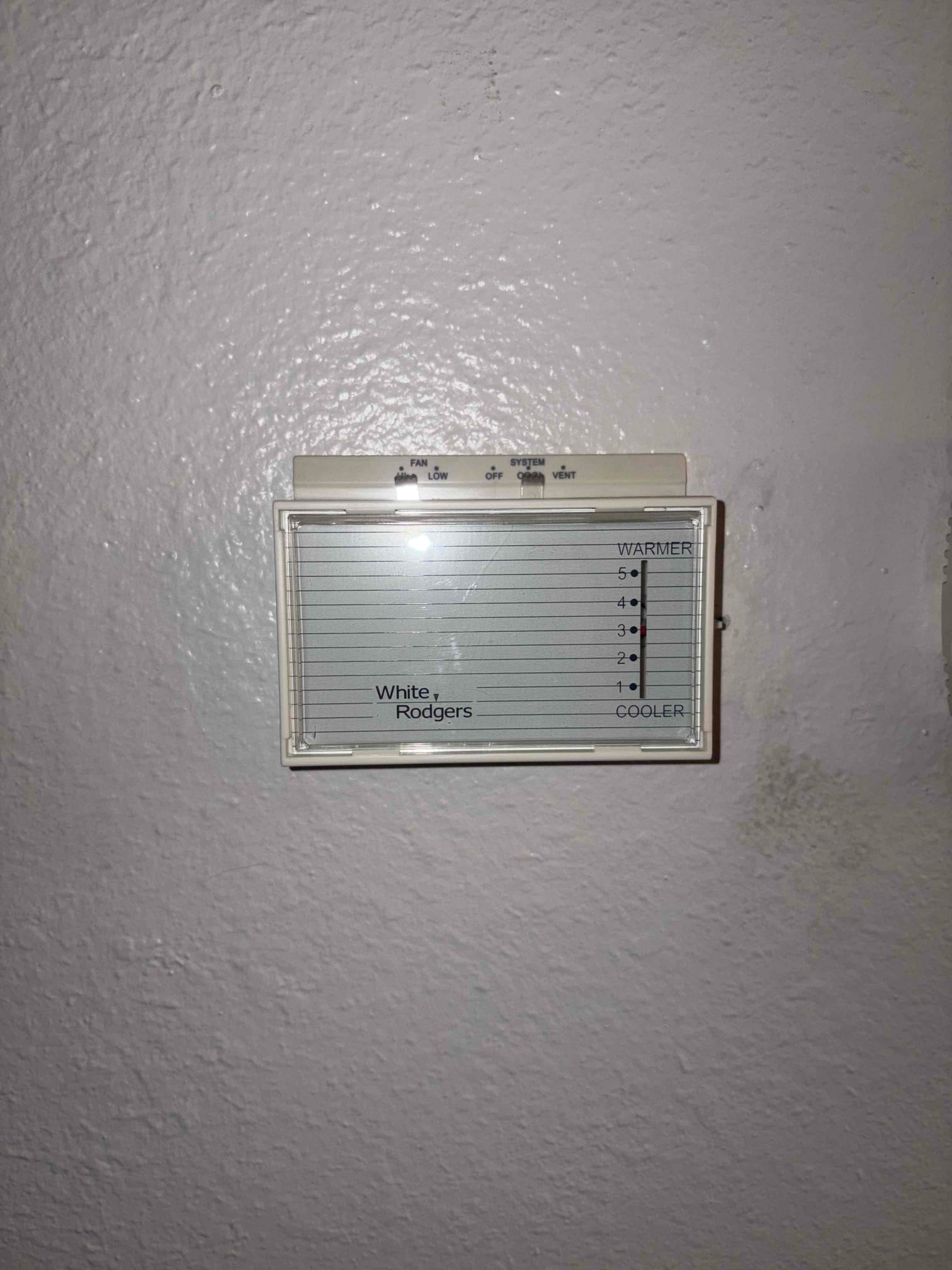 Refrigerant scale photographed during the service visit; no numerical reading is transcribed.