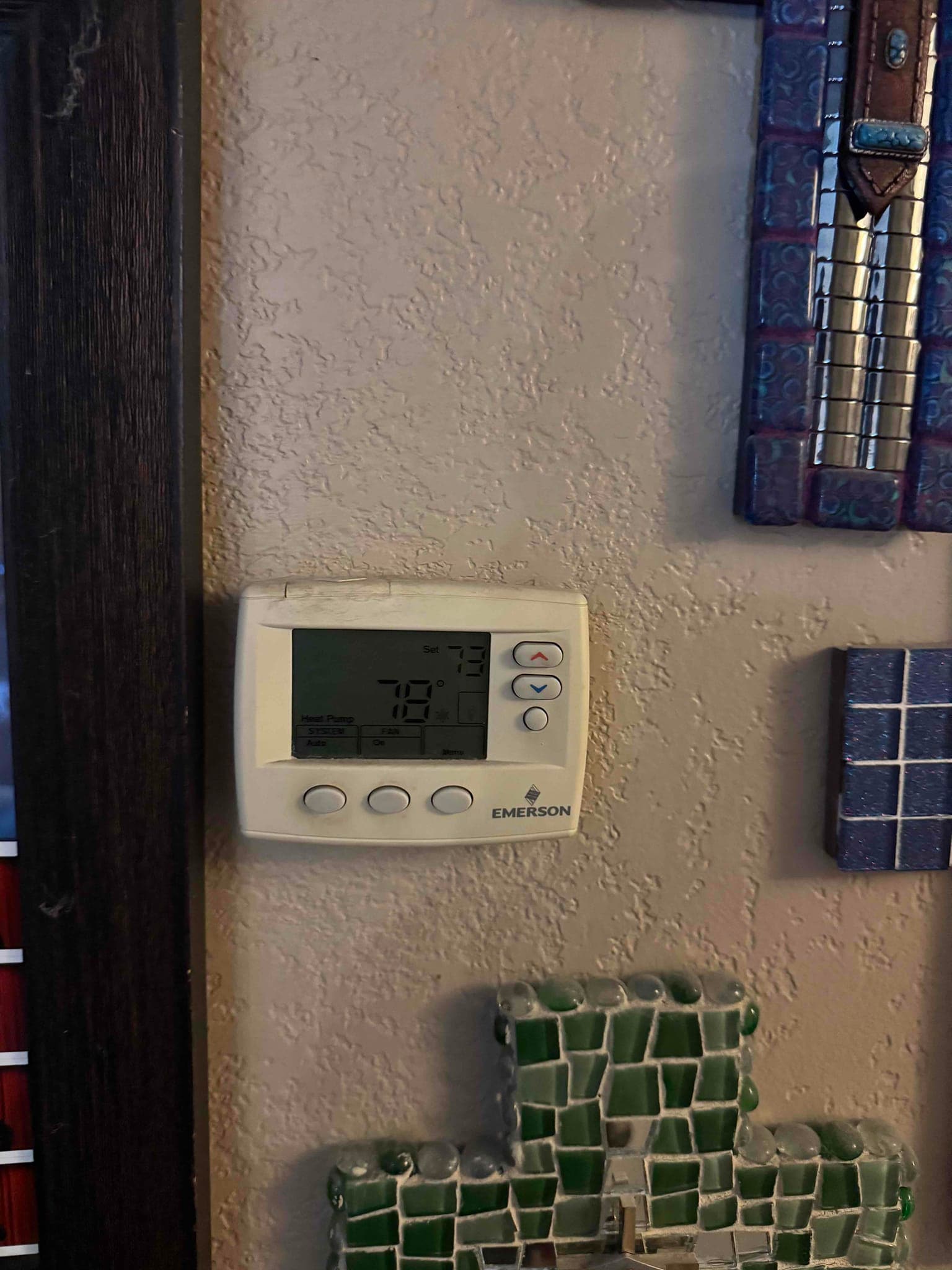 Wall-mounted digital thermostat displays 78°F room temperature with cooling set to 73°F.
