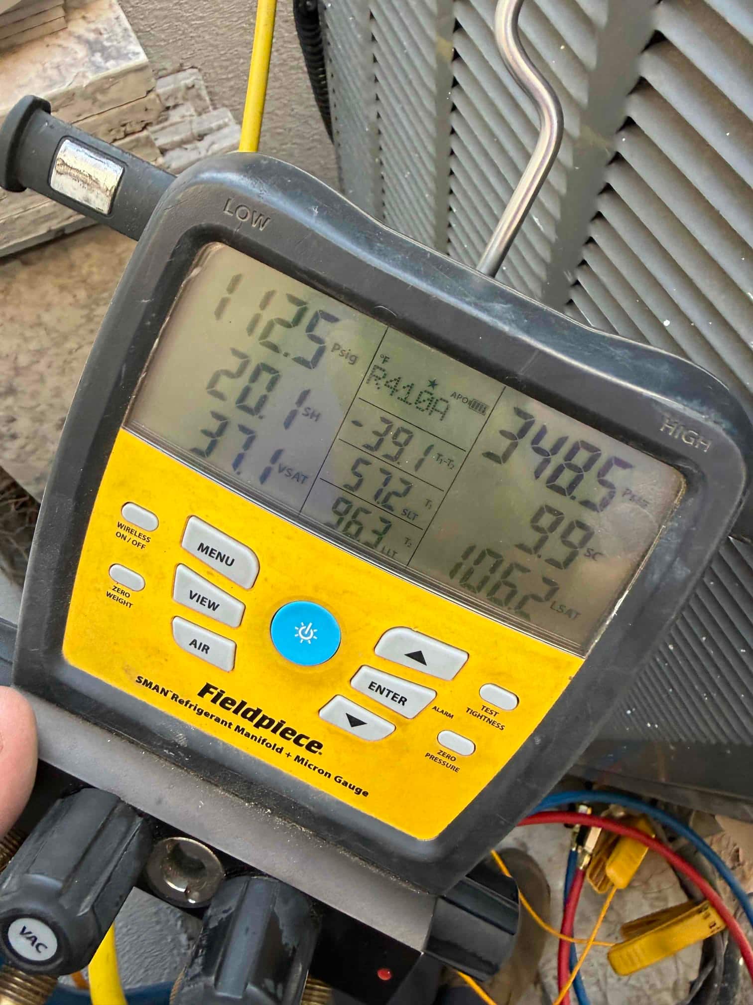 HVAC diagnostic instrument photographed during the service visit.