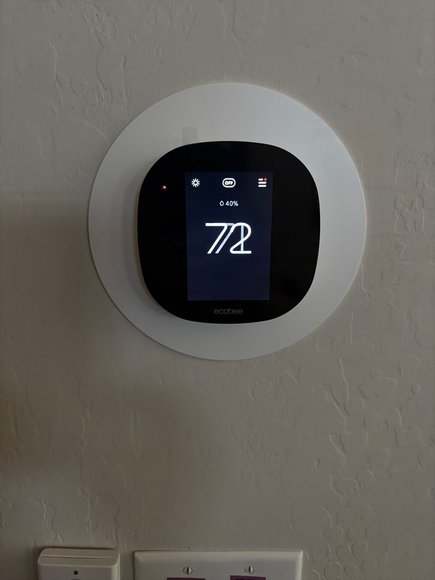 Wall-mounted thermostat display shows system OFF, large 72 on screen, and a humidity icon indicating 40%.